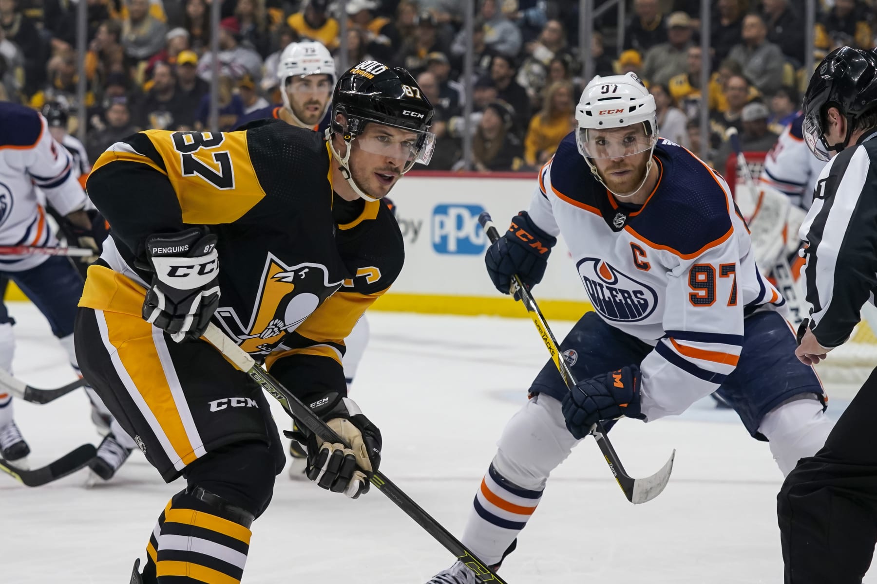 PITTSBURGH, PA - APRIL 26: Pittsburgh Penguins Center Sidney Crosby (87) and Edmonton Oilers Center Connor McDavid (97) face-off during the first period in the NHL game between the Pittsburgh Penguins and the Edmonton Oilers on April 26, 2022, at PPG Paints Arena in Pittsburgh, PA. (Photo by Jeanine Leech/Icon Sportswire via Getty Images)