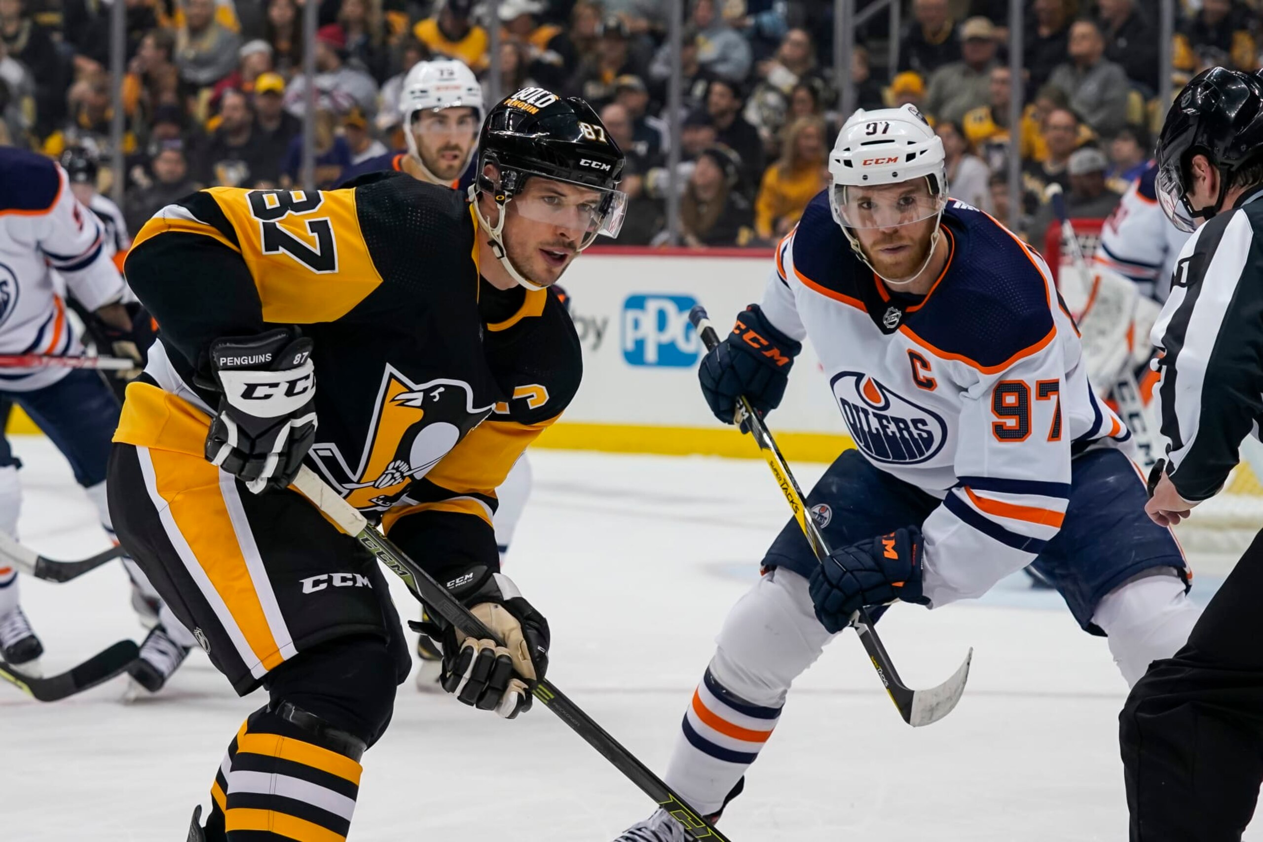 PITTSBURGH, PA - APRIL 26: Pittsburgh Penguins Center Sidney Crosby (87) and Edmonton Oilers Center Connor McDavid (97) face-off during the first period in the NHL game between the Pittsburgh Penguins and the Edmonton Oilers on April 26, 2022, at PPG Paints Arena in Pittsburgh, PA. (Photo by Jeanine Leech/Icon Sportswire via Getty Images)