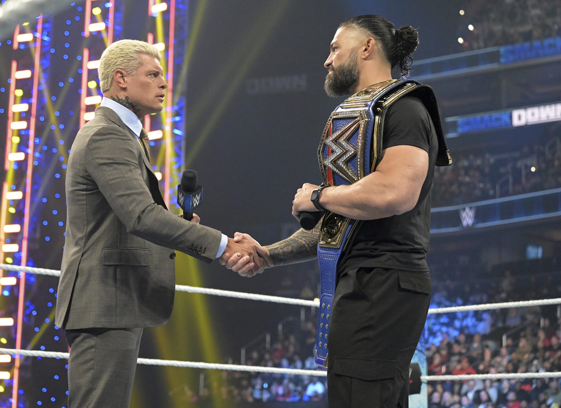Cody Rhodes, left, and Roman Reigns meet in the center of the ring during an episode of WWE Smackdown on March 3, 2023, in Washington. Rhodes and Reigns will be in the main event of WrestleMania 39 on Sunday, April 2, 2023, in Los Angeles. (WWE via AP)