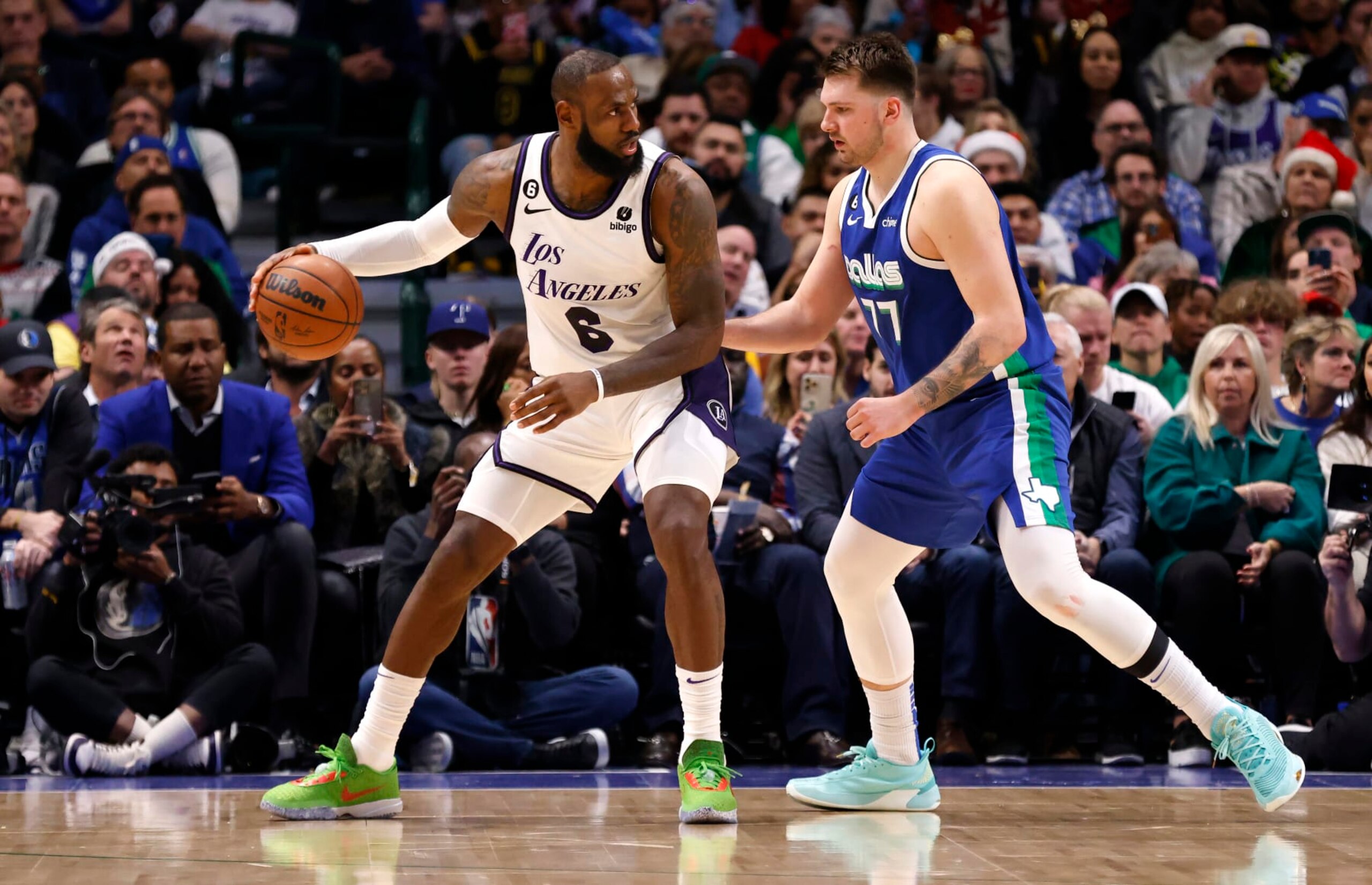 DALLAS, TX - DECEMBER 25: LeBron James #6 of the Los Angeles Lakers handles the ball as Luka Doncic #77 of the Dallas Mavericks defends in the second half at American Airlines Center on December 25, 2022 in Dallas, Texas. NOTE TO USER: User expressly acknowledges and agrees that, by downloading and or using this photograph, User is consenting to the terms and conditions of the Getty Images License Agreement. (Photo by Ron Jenkins/Getty Images)
