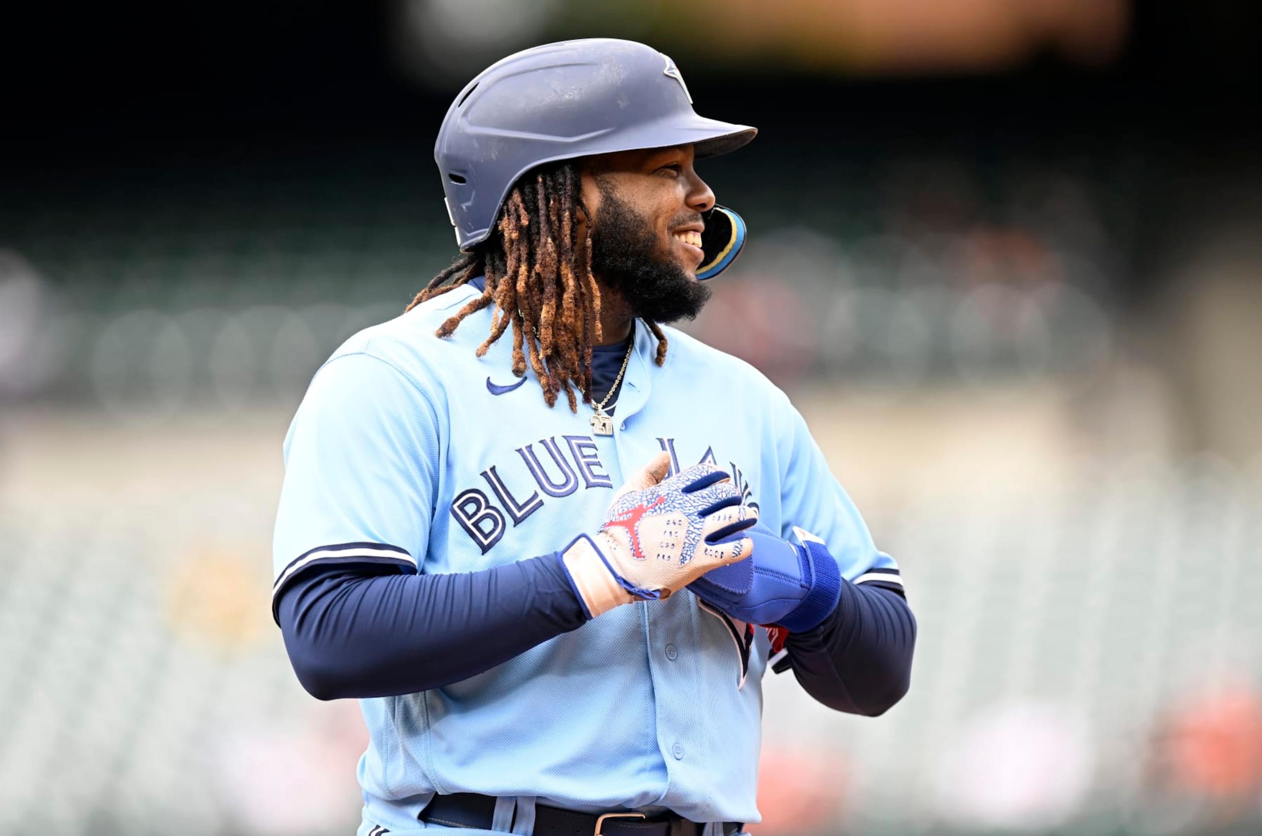 BALTIMORE, MARYLAND - OCTOBER 05: Vladimir Guerrero Jr. #27 of the Toronto Blue Jays stands on first base against the Baltimore Orioles during game one of a doubleheader at Oriole Park at Camden Yards on October 05, 2022 in Baltimore, Maryland. (Photo by G Fiume/Getty Images)