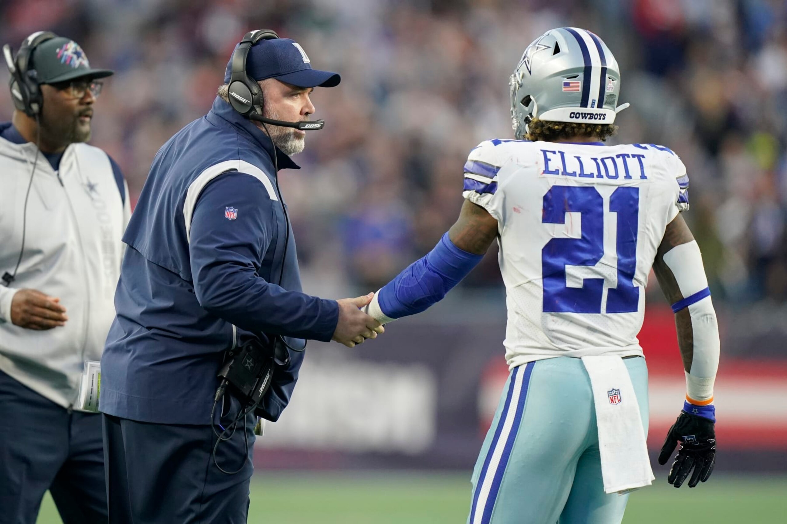 Dallas Cowboys head coach Mike McCarthy talks with running back Ezekiel Elliott (21) during the first half of an NFL football game, Sunday, Oct. 17, 2021, in Foxborough, Mass. (AP Photo/Steven Senne) Dallas Cowboys head coach Mike McCarthy talks with running back Ezekiel Elliott (21) during the first half of an NFL football game, Sunday, Oct. 17, 2021, in Foxborough, Mass. (AP Photo/Steven Senne)