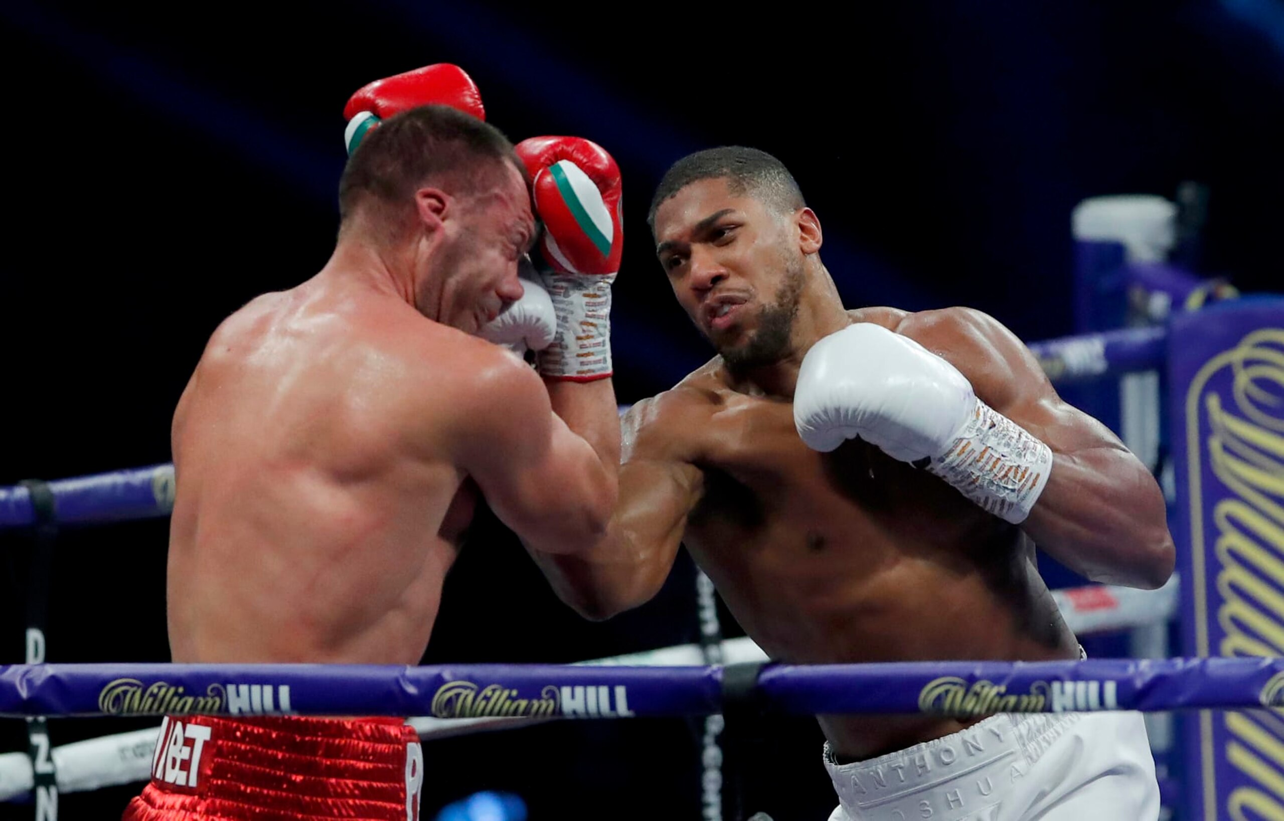 LONDON, ENGLAND - DECEMBER 12: Anthony Joshua punches Kubrat Pulev during the IBF, WBA, WBO and IBO World Heayweight Title fight between Anthony Joshua and Kubrat Pulev at The SSE Arena, Wembley on December 12, 2020 in London, England. A limited number of fans (1000) are welcomed back to sporting venues to watch elite sport across England. This was following easing of restrictions on spectators in tiers one and two areas only. (Photo by Andrew Couldridge - Pool/Getty Images)