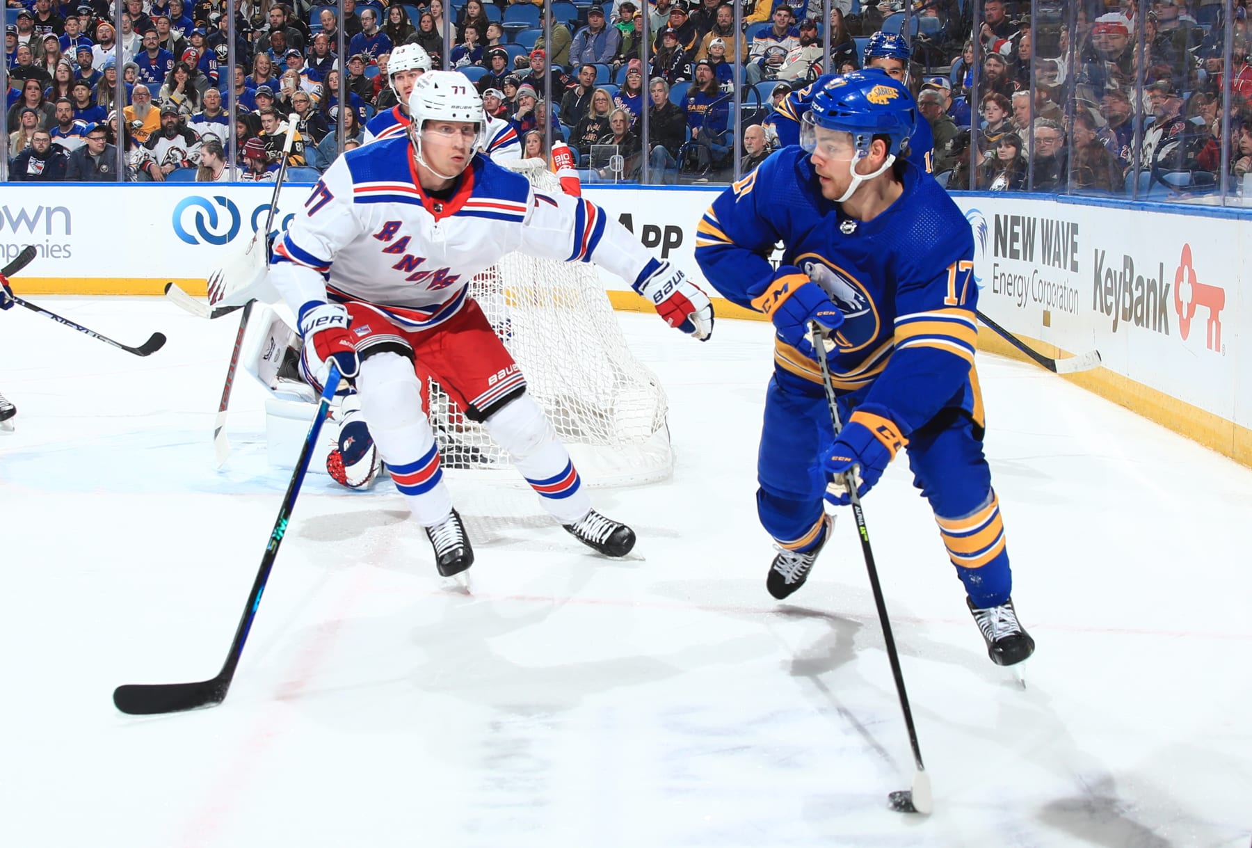 BUFFALO, NY - MARCH 31: Tyson Jost #17 of the Buffalo Sabres skates with the puck against Niko Mikkola #77 of the New York Rangers during an NHL game on March 31, 2023 at KeyBank Center in Buffalo, New York. (Photo by Bill Wippert/NHLI via Getty Images)