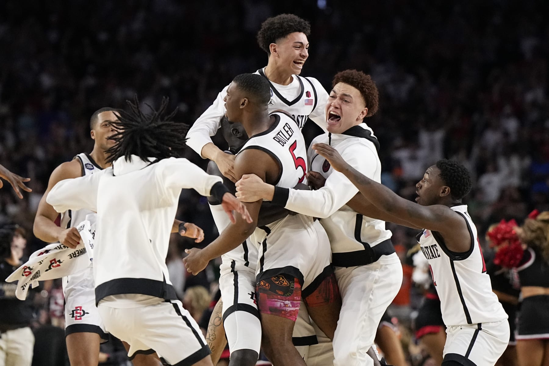 San Diego State guard Lamont Butler (5) celebrates with teammates after scoring the winning basket against Florida Atlantic during a Final Four college basketball game in the NCAA Tournament on Saturday, April 1, 2023, in Houston. (AP Photo/Brynn Anderson) San Diego State guard Lamont Butler (5) celebrates with teammates after scoring the winning basket against Florida Atlantic during a Final Four college basketball game in the NCAA Tournament on Saturday, April 1, 2023, in Houston. (AP Photo/Brynn Anderson)
