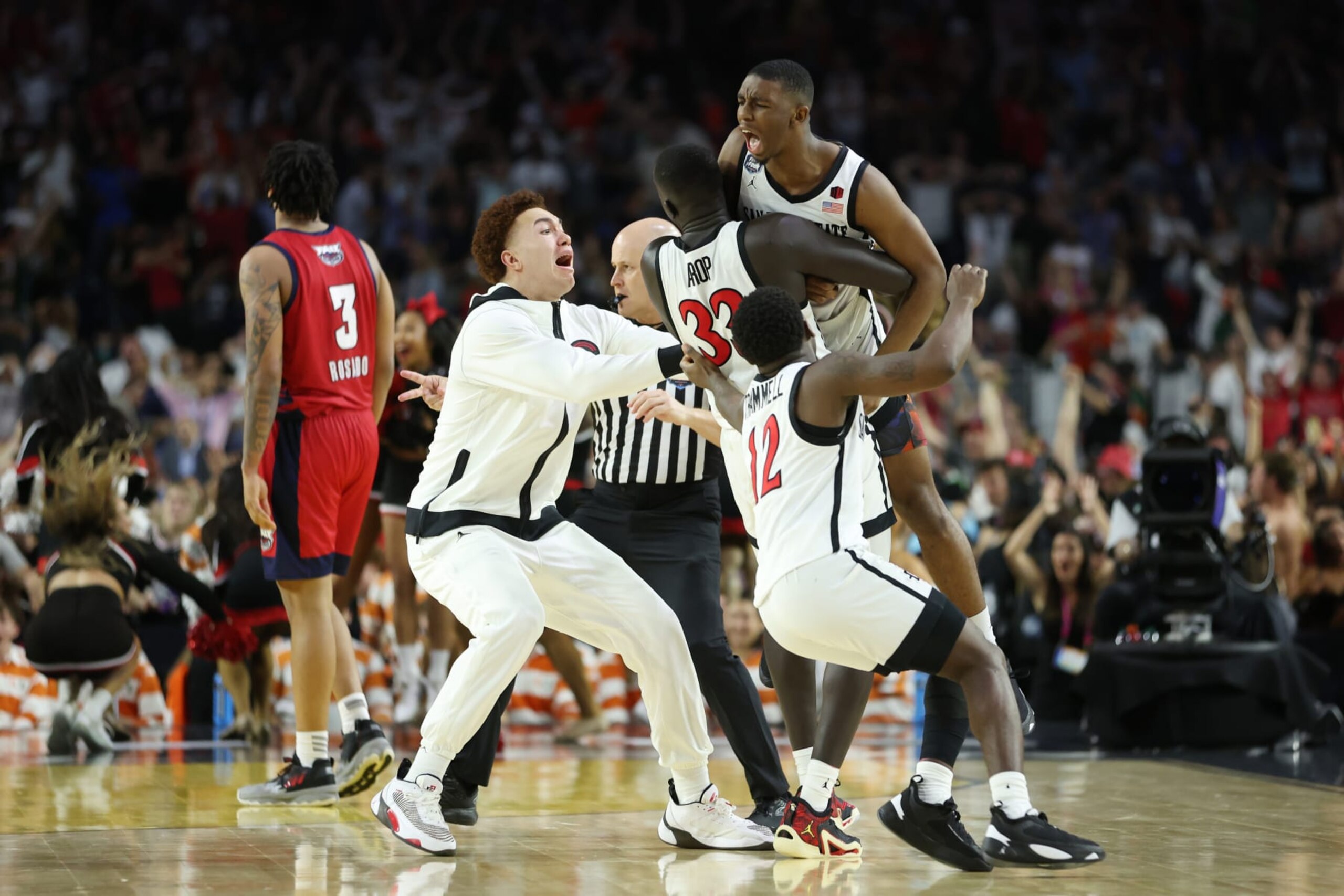 HOUSTON, TEXAS - APRIL 01: Lamont Butler #5 of the San Diego State Aztecs celebrates with teammates after making a game winning basket to defeat the Florida Atlantic Owls 72-71 during the NCAA Men's Basketball Tournament Final Four semifinal game at NRG Stadium on April 01, 2023 in Houston, Texas. (Photo by Gregory Shamus/Getty Images)