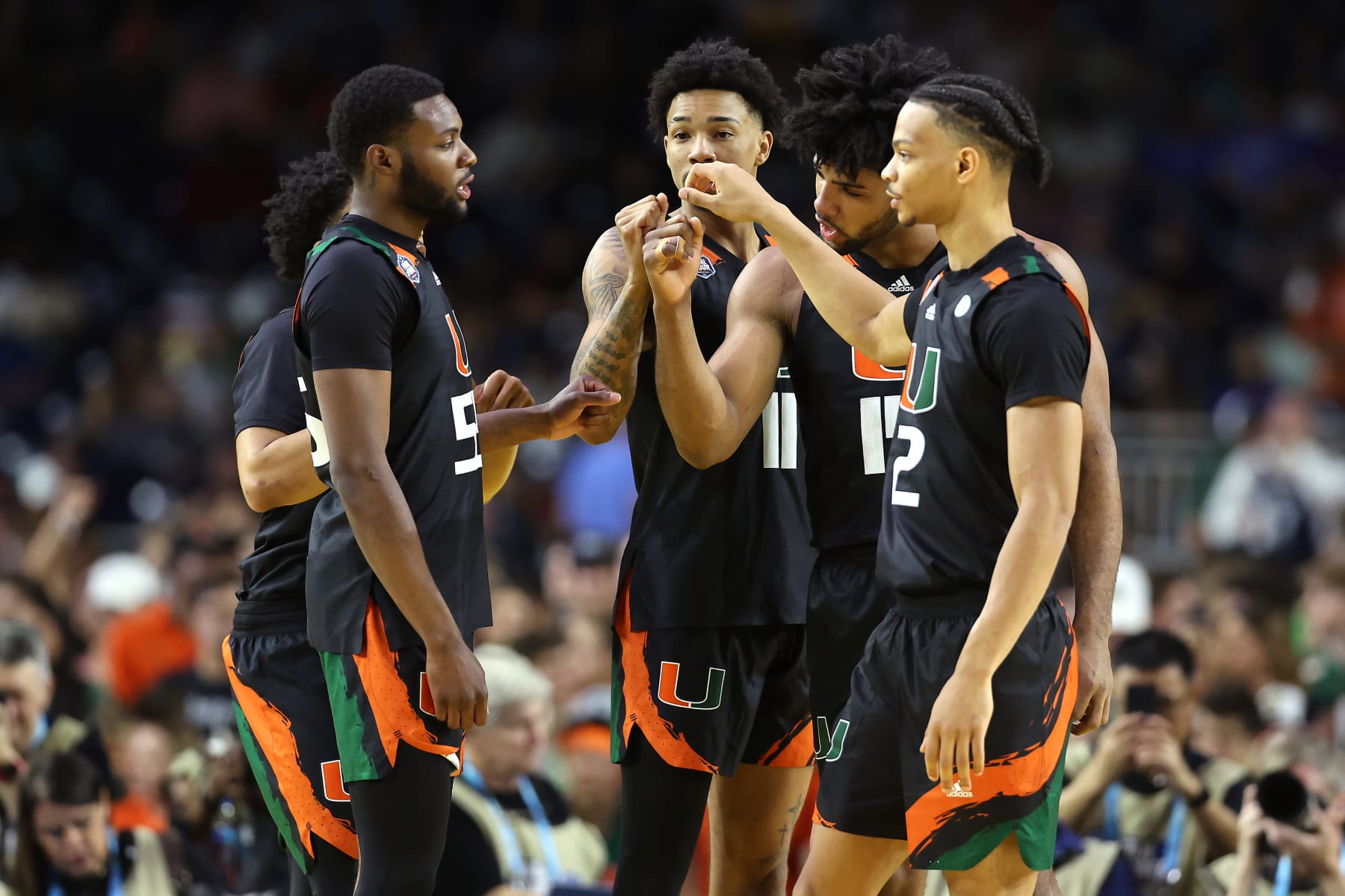 HOUSTON, TEXAS - APRIL 01: Isaiah Wong #2 of the Miami Hurricanes and teammates huddle prior to the game against the Connecticut Huskies during the NCAA Men's Basketball Tournament Final Four semifinal game at NRG Stadium on April 01, 2023 in Houston, Texas. (Photo by Gregory Shamus/Getty Images)