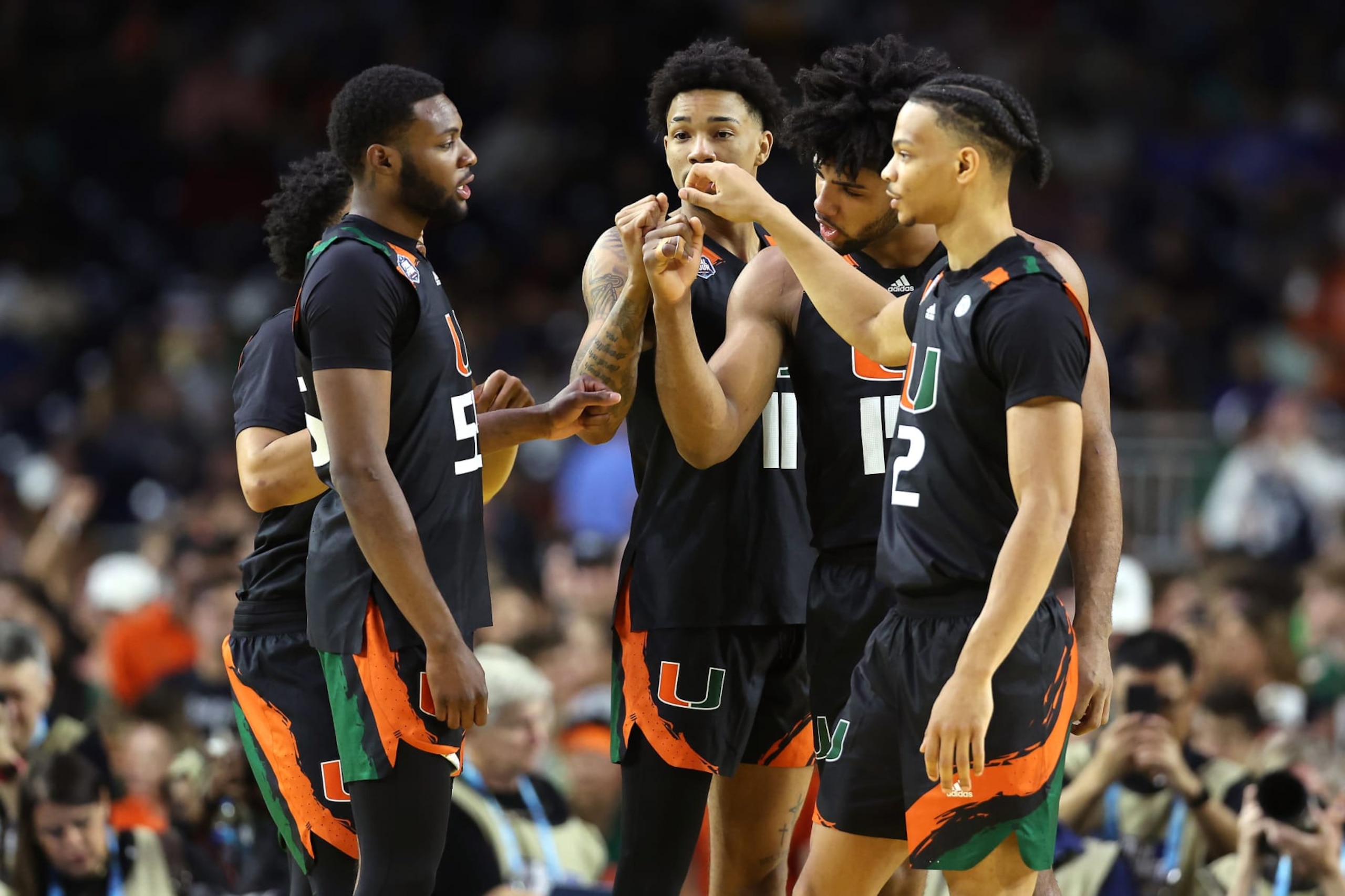 HOUSTON, TEXAS - APRIL 01: Isaiah Wong #2 of the Miami Hurricanes and teammates huddle prior to the game against the Connecticut Huskies during the NCAA Men's Basketball Tournament Final Four semifinal game at NRG Stadium on April 01, 2023 in Houston, Texas. (Photo by Gregory Shamus/Getty Images) HOUSTON, TEXAS - APRIL 01: Isaiah Wong #2 of the Miami Hurricanes and teammates huddle prior to the game against the Connecticut Huskies during the NCAA Men's Basketball Tournament Final Four semifinal game at NRG Stadium on April 01, 2023 in Houston, Texas. (Photo by Gregory Shamus/Getty Images)