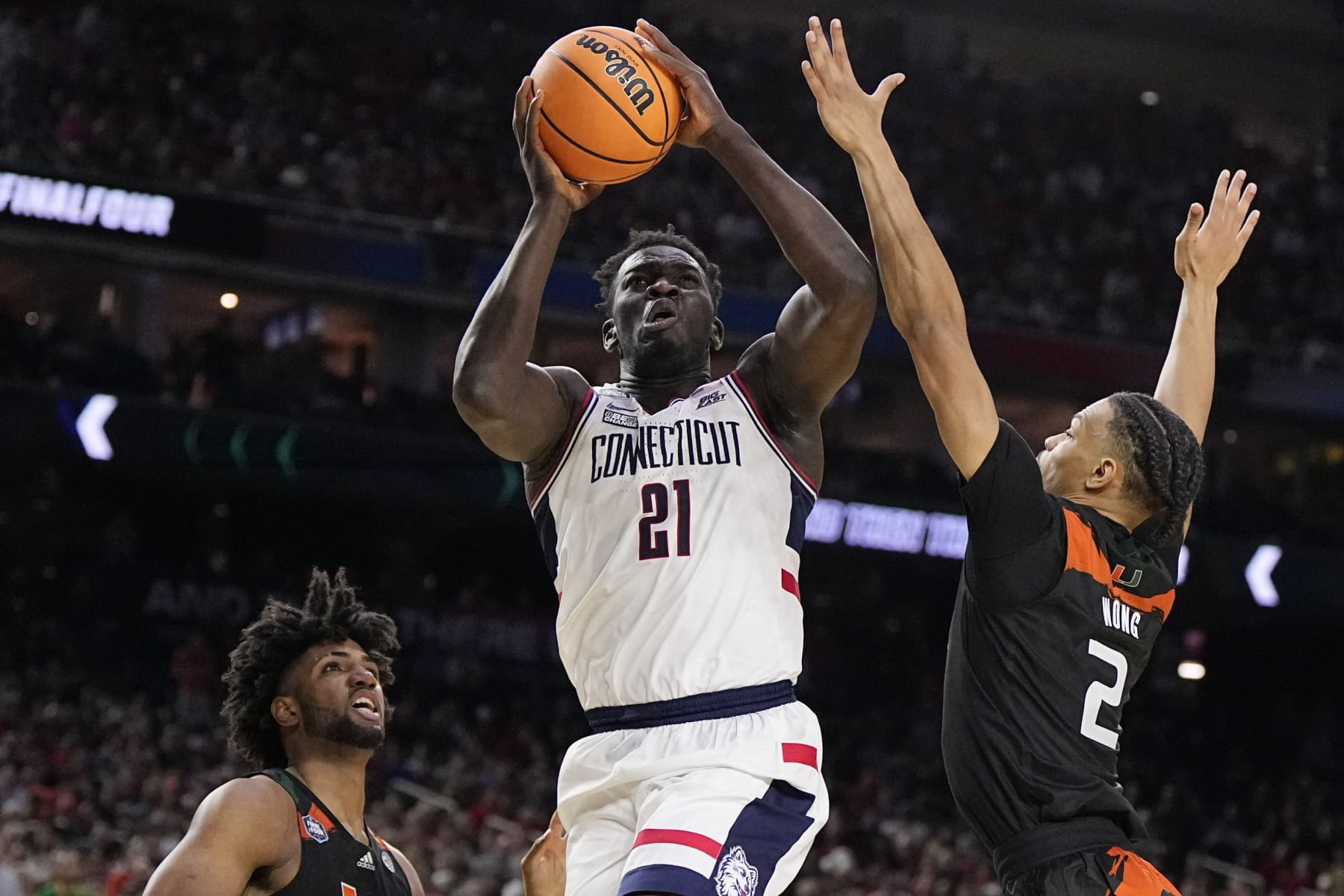 Connecticut forward Adama Sanogo scores past Miami guard Isaiah Wong during the second half of a Final Four college basketball game in the NCAA Tournament on Saturday, April 1, 2023, in Houston. (AP Photo/Brynn Anderson) Connecticut forward Adama Sanogo scores past Miami guard Isaiah Wong during the second half of a Final Four college basketball game in the NCAA Tournament on Saturday, April 1, 2023, in Houston. (AP Photo/Brynn Anderson)
