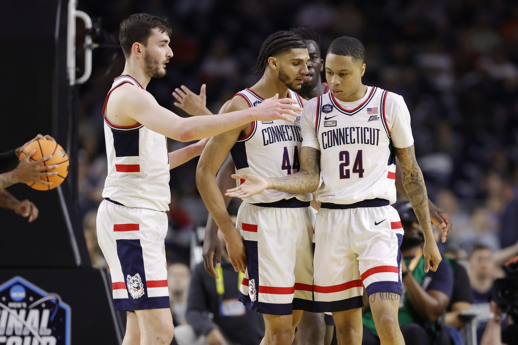 HOUSTON, TEXAS - APRIL 01: Jordan Hawkins #24 of the Connecticut Huskies celebrates with teammates during the second half against the Miami Hurricanes during the NCAA Men's Basketball Tournament Final Four semifinal game at NRG Stadium on April 01, 2023 in Houston, Texas. (Photo by Carmen Mandato/Getty Images)