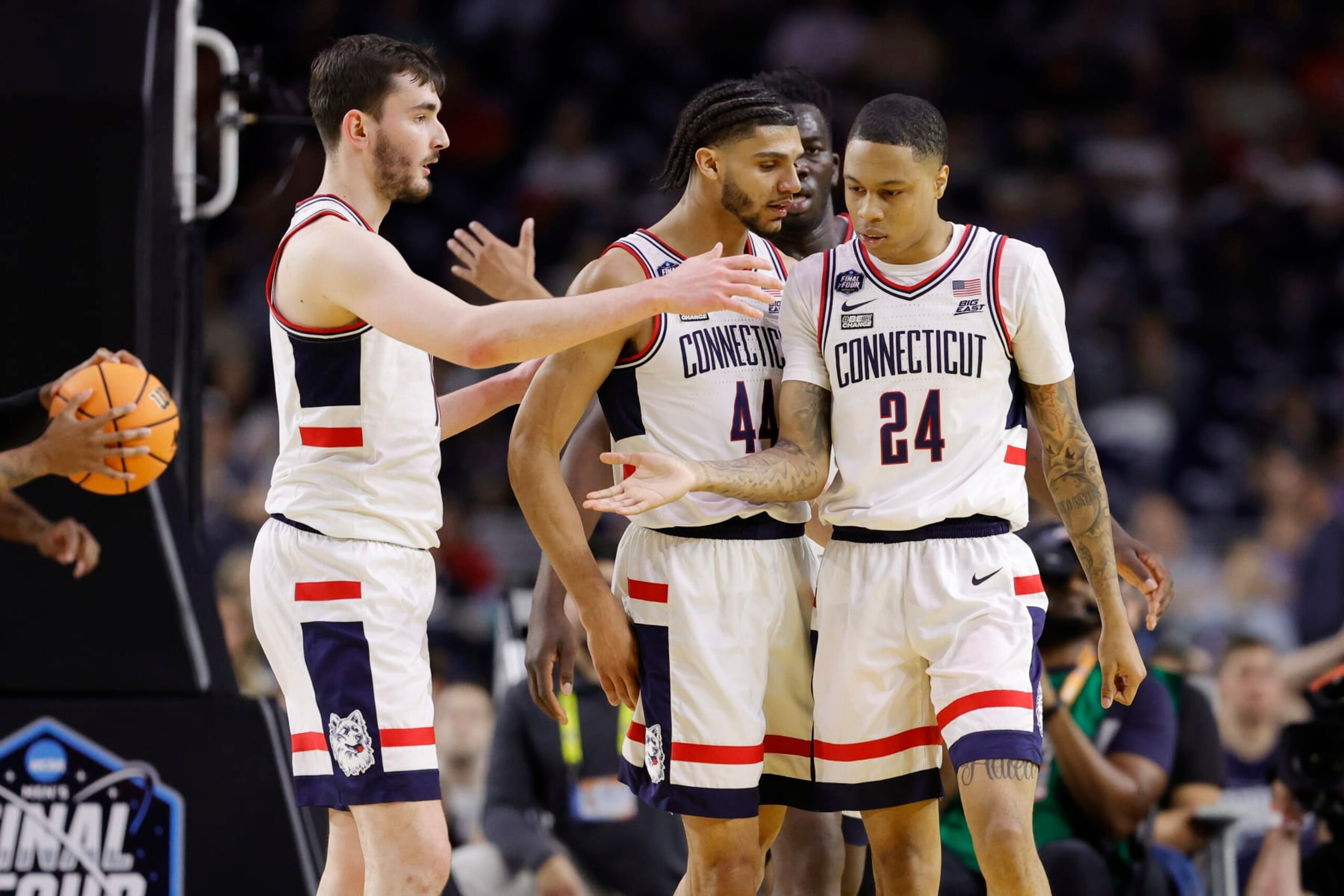 HOUSTON, TEXAS - APRIL 01: Jordan Hawkins #24 of the Connecticut Huskies celebrates with teammates during the second half against the Miami Hurricanes during the NCAA Men's Basketball Tournament Final Four semifinal game at NRG Stadium on April 01, 2023 in Houston, Texas. (Photo by Carmen Mandato/Getty Images)