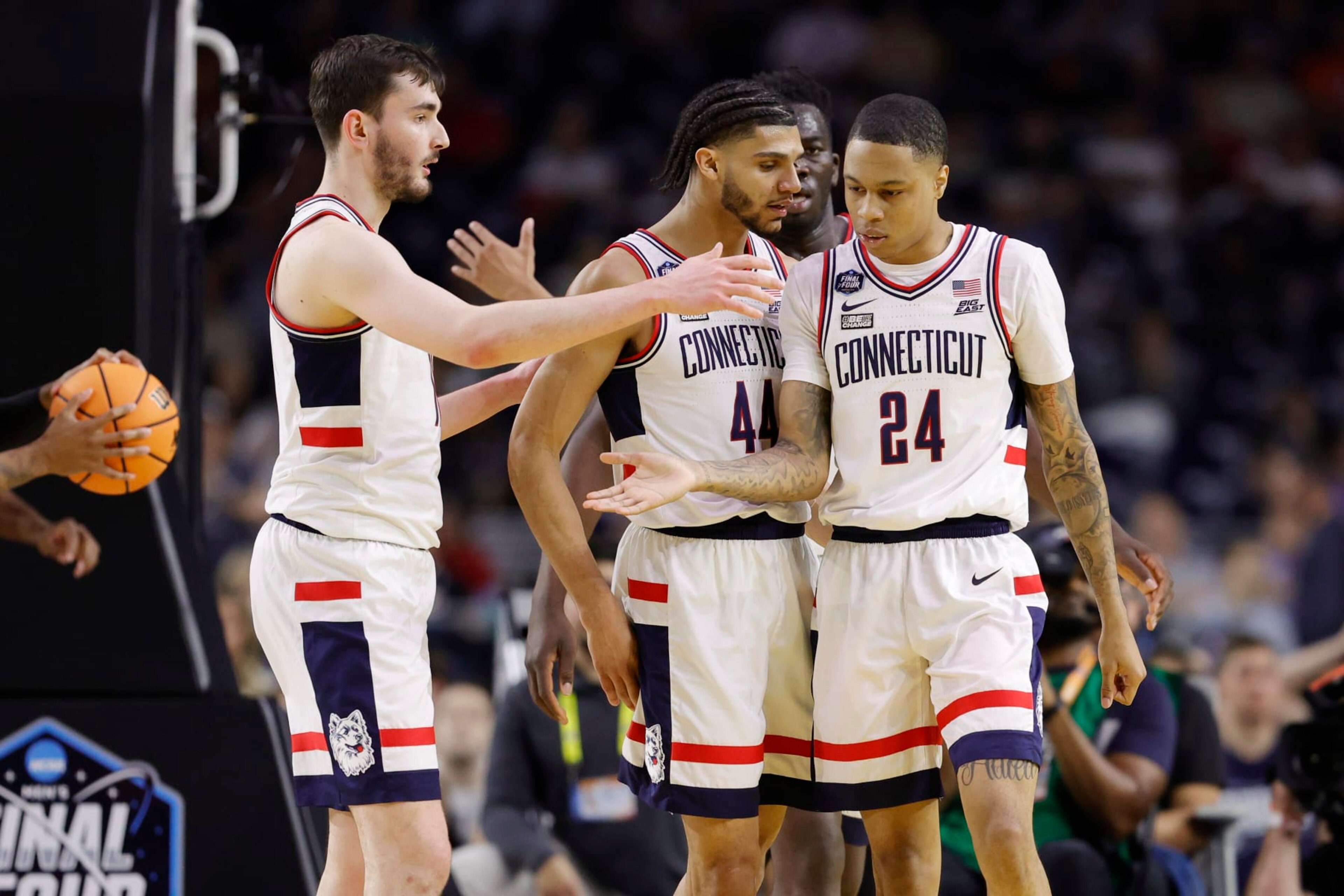 HOUSTON, TEXAS - APRIL 01: Jordan Hawkins #24 of the Connecticut Huskies celebrates with teammates during the second half against the Miami Hurricanes during the NCAA Men's Basketball Tournament Final Four semifinal game at NRG Stadium on April 01, 2023 in Houston, Texas. (Photo by Carmen Mandato/Getty Images)