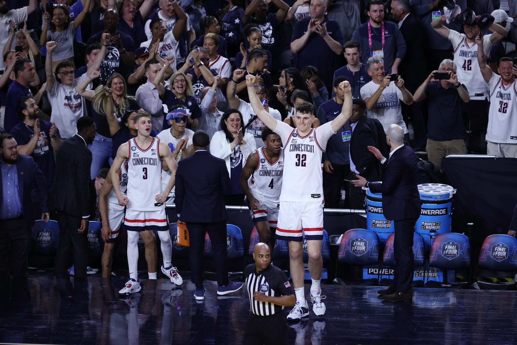 HOUSTON, TEXAS - APRIL 01: Donovan Clingan #32 of the Connecticut Huskies celebrates on the sidelines after defeating the  Miami (Fl) Hurricanes during the NCAA Men’s Basketball Tournament Final Four semifinal game at NRG Stadium on April 01, 2023 in Houston, Texas. (Photo by Tyler Schank/NCAA Photos via Getty Images)
