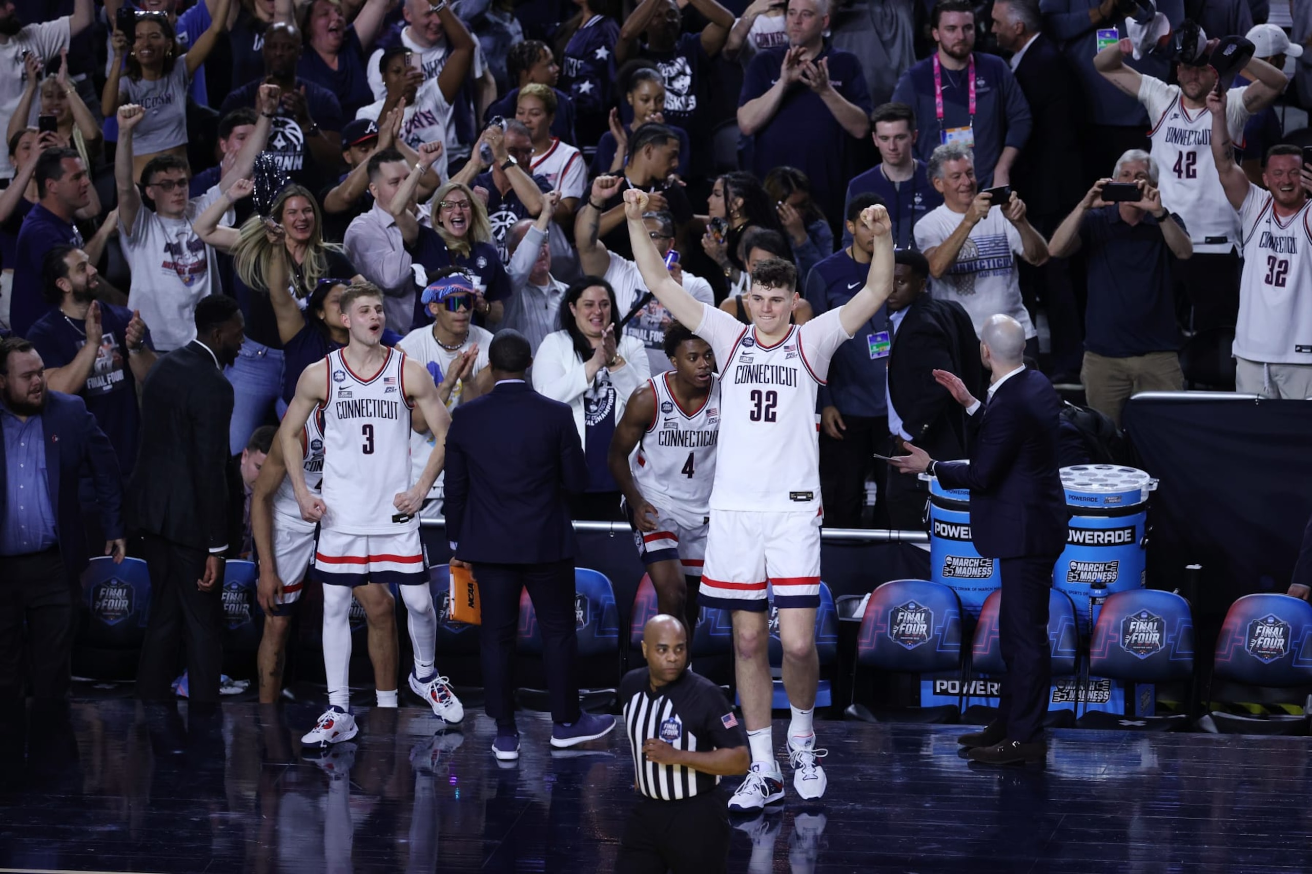 HOUSTON, TEXAS - APRIL 01: Donovan Clingan #32 of the Connecticut Huskies celebrates on the sidelines after defeating the  Miami (Fl) Hurricanes during the NCAA Men’s Basketball Tournament Final Four semifinal game at NRG Stadium on April 01, 2023 in Houston, Texas. (Photo by Tyler Schank/NCAA Photos via Getty Images)