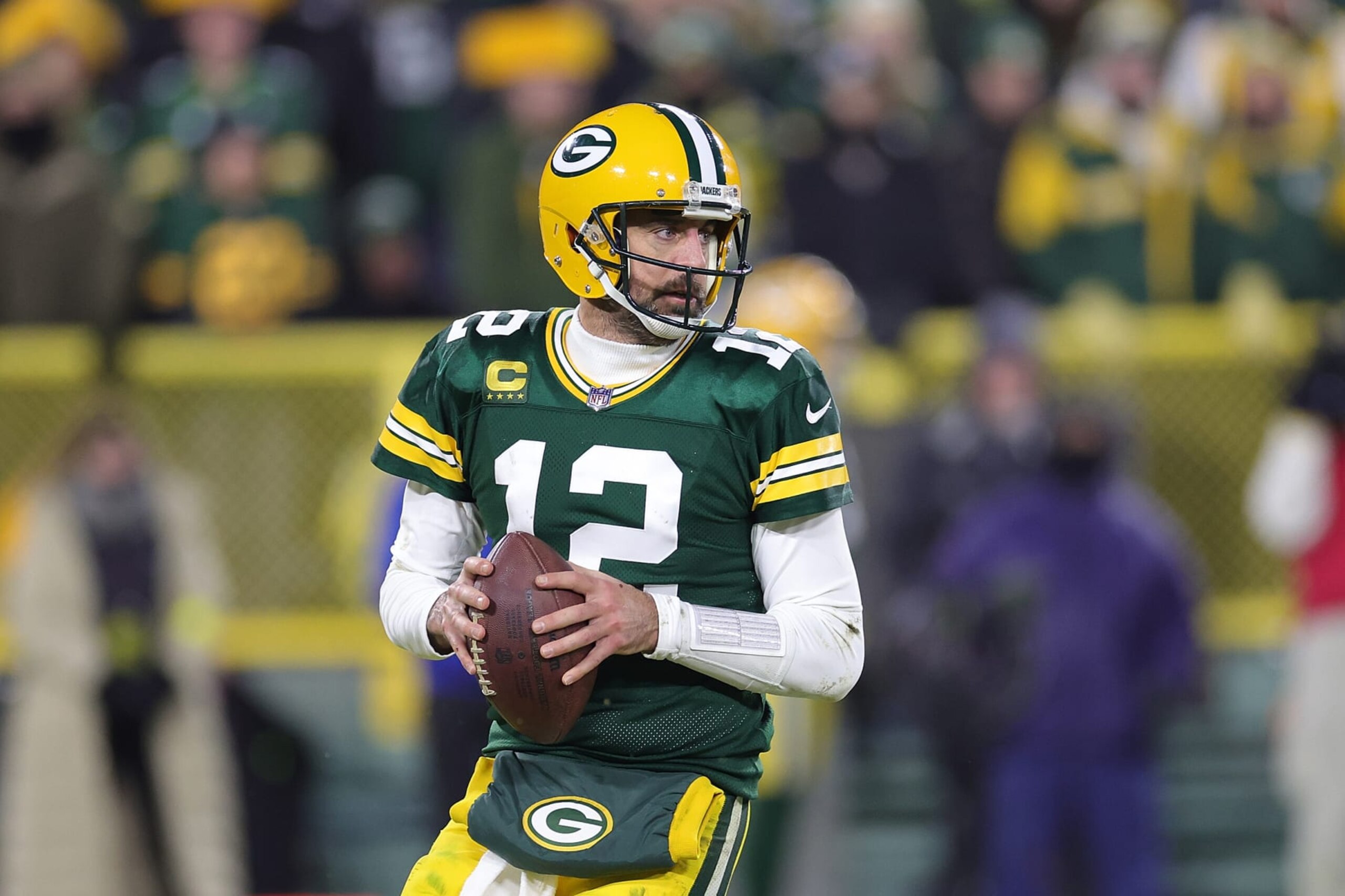 GREEN BAY, WISCONSIN - JANUARY 08: Aaron Rodgers #12 of the Green Bay Packers drops back to pass during a game against the Detroit Lions at Lambeau Field on January 08, 2023 in Green Bay, Wisconsin. The Lions defeated the Packers 20-16. (Photo by Stacy Revere/Getty Images) GREEN BAY, WISCONSIN - JANUARY 08: Aaron Rodgers #12 of the Green Bay Packers drops back to pass during a game against the Detroit Lions at Lambeau Field on January 08, 2023 in Green Bay, Wisconsin. The Lions defeated the Packers 20-16. (Photo by Stacy Revere/Getty Images)