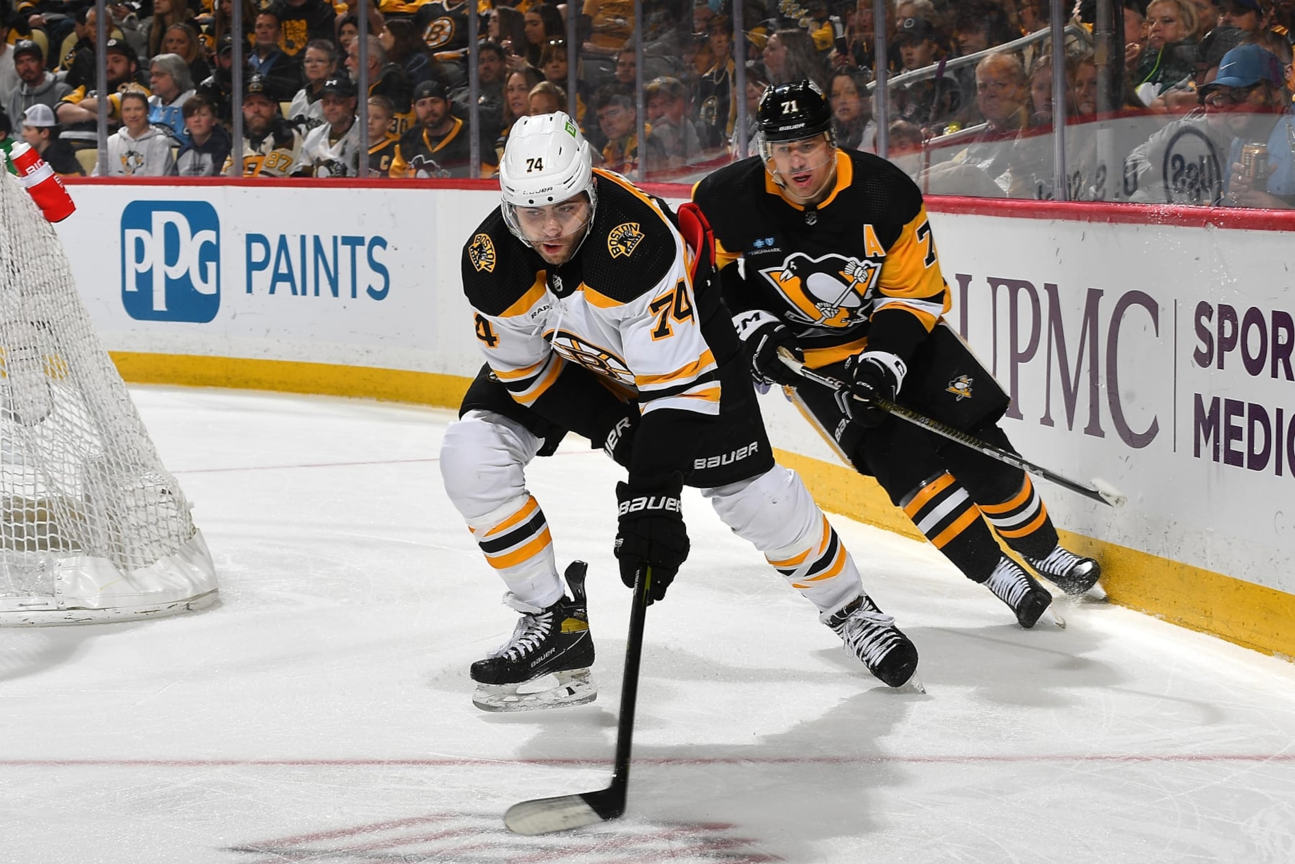 PITTSBURGH, PA - APRIL 01:  Jake DeBrusk #74 of the Boston Bruins skates against Evgeni Malkin #71 of the Pittsburgh Penguins at PPG PAINTS Arena on April 1, 2023 in Pittsburgh, Pennsylvania. (Photo by Joe Sargent/NHLI via Getty Images)