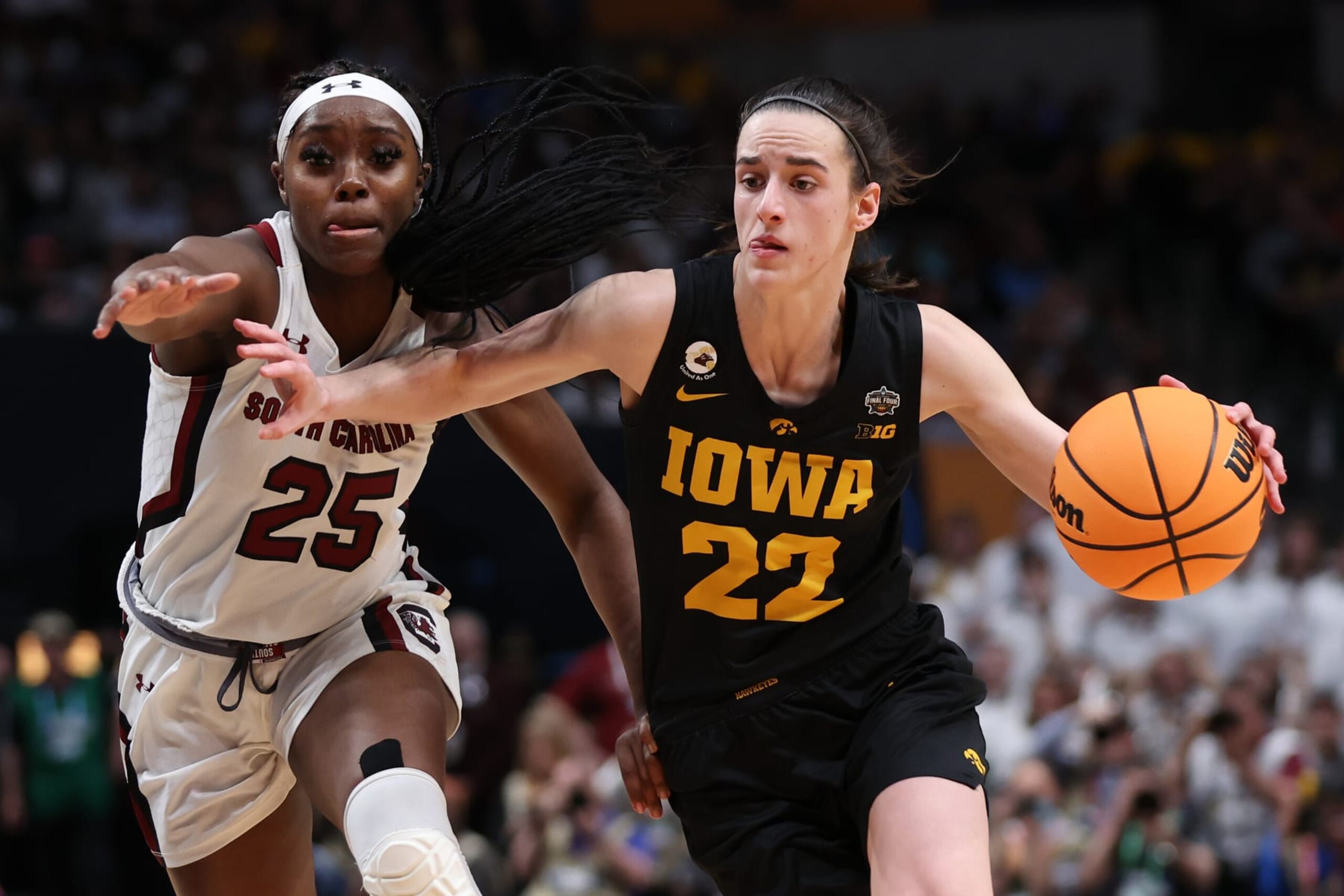 DALLAS, TEXAS - MARCH 31: Caitlin Clark #22 of the Iowa Hawkeyes dribbles against Raven Johnson #25 of the South Carolina Gamecocks during the third quarter during the 2023 NCAA Women's Basketball Tournament Final Four semifinal game at American Airlines Center on March 31, 2023 in Dallas, Texas. (Photo by Maddie Meyer/Getty Images)