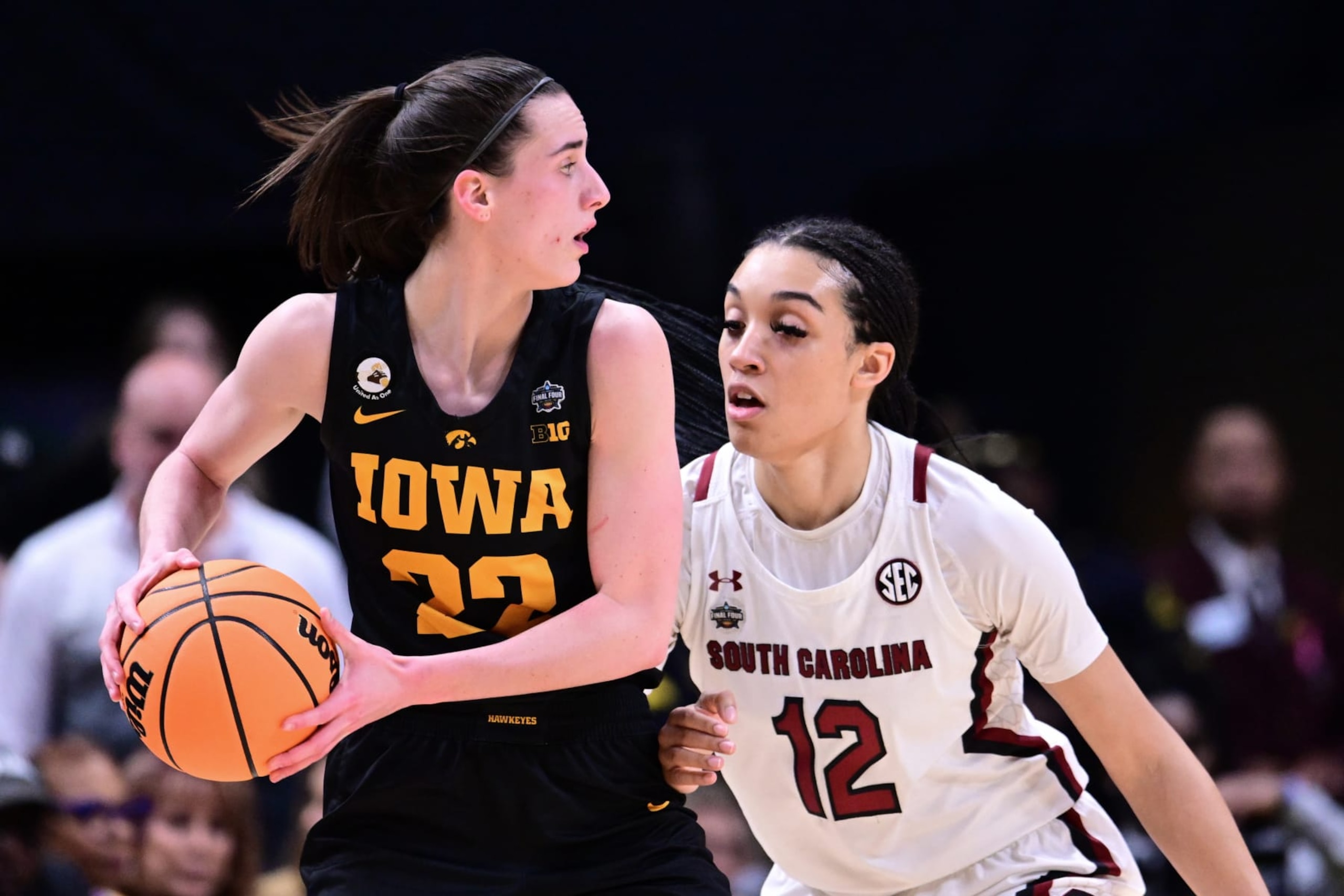 DALLAS, TX - MARCH 31: Caitlin Clark #22 of the Iowa Hawkeyes looks for an open pass as Brea Beal #12 of the South Carolina Gamecocks  defends during the semifinals of the NCAA Womens Basketball Tournament Final Four at American Airlines Center on March 31, 2023 in Dallas, Texas. (Photo by Ben Solomon/NCAA Photos via Getty Images)