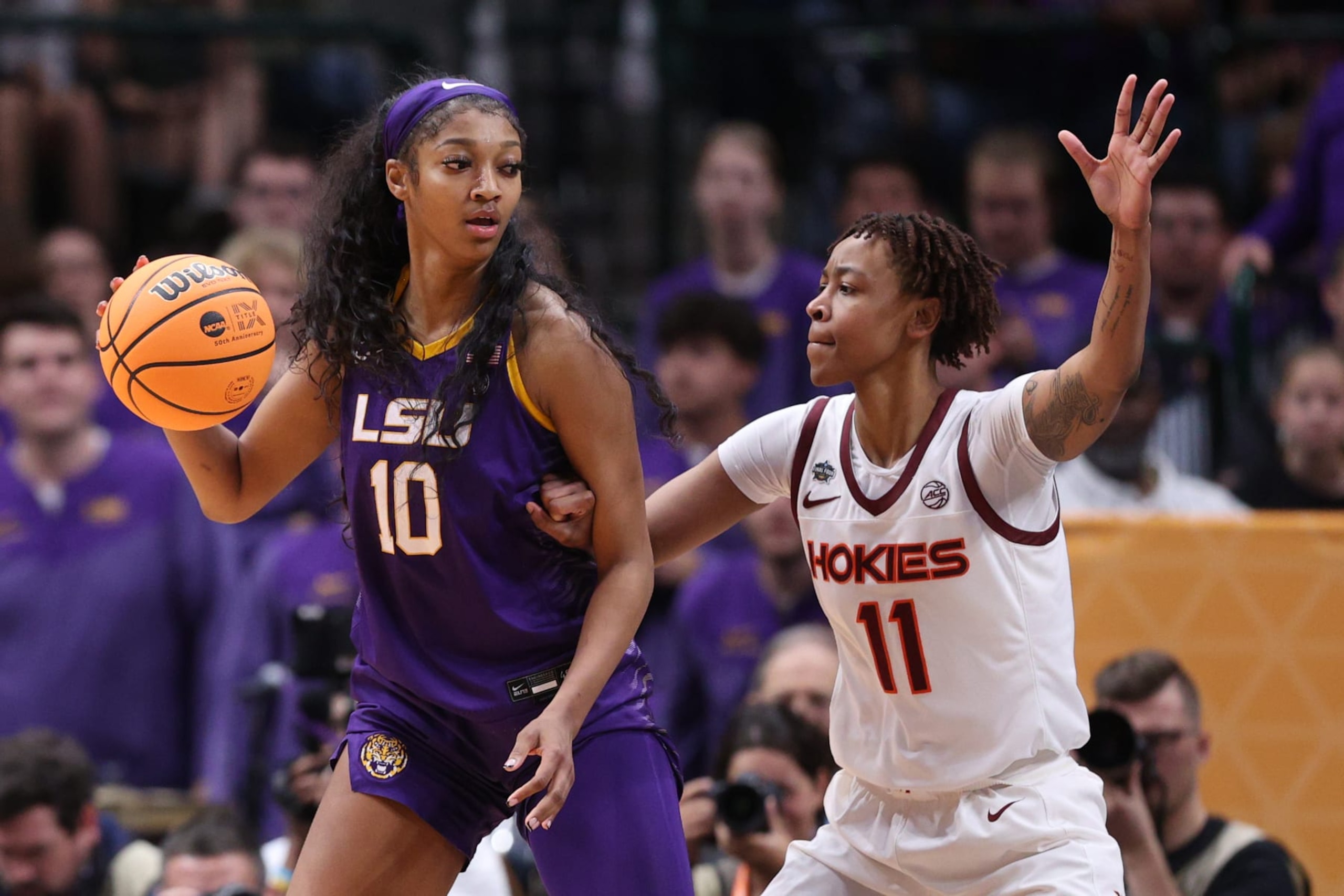 DALLAS, TEXAS - MARCH 31: Angel Reese #10 of the LSU Lady Tigers dribbles against D'asia Gregg #11 of the Virginia Tech Hokies during the fourth quarter during the 2023 NCAA Women's Basketball Tournament Final Four semifinal game at American Airlines Center on March 31, 2023 in Dallas, Texas. (Photo by Maddie Meyer/Getty Images)
