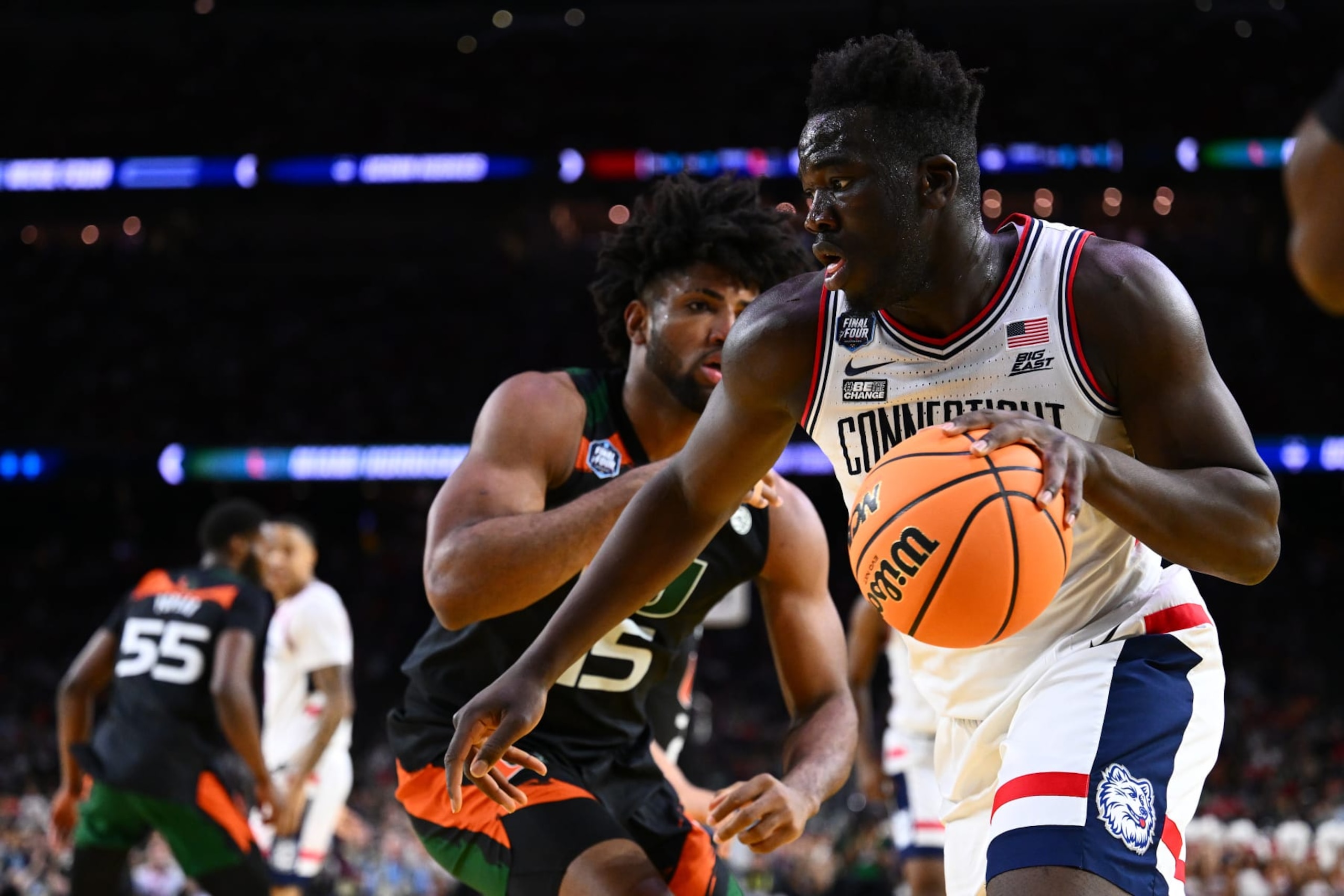 HOUSTON, TEXAS - APRIL 01: Adama Sanogo #21 of the Connecticut Huskies drives to the basket against Norchad Omier #15 of the Miami (Fl) Hurricanes in the first half during the NCAA Men’s Basketball Tournament Final Four semifinal game at NRG Stadium on April 01, 2023 in Houston, Texas. (Photo by Brett Wilhelm/NCAA Photos via Getty Images)