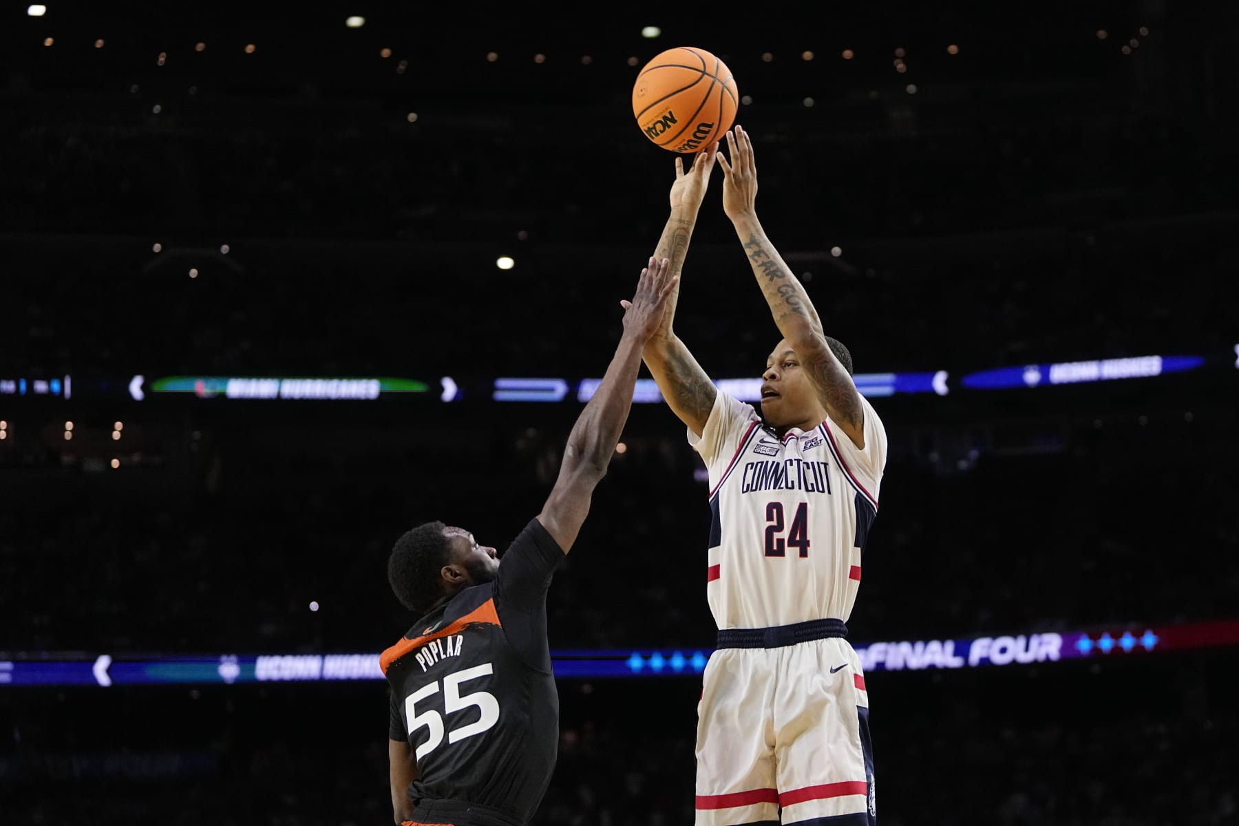 Connecticut guard Jordan Hawkins shoots over Miami guard Wooga Poplar during the first half of a Final Four college basketball game in the NCAA Tournament on Saturday, April 1, 2023, in Houston. (AP Photo/David J. Phillip)