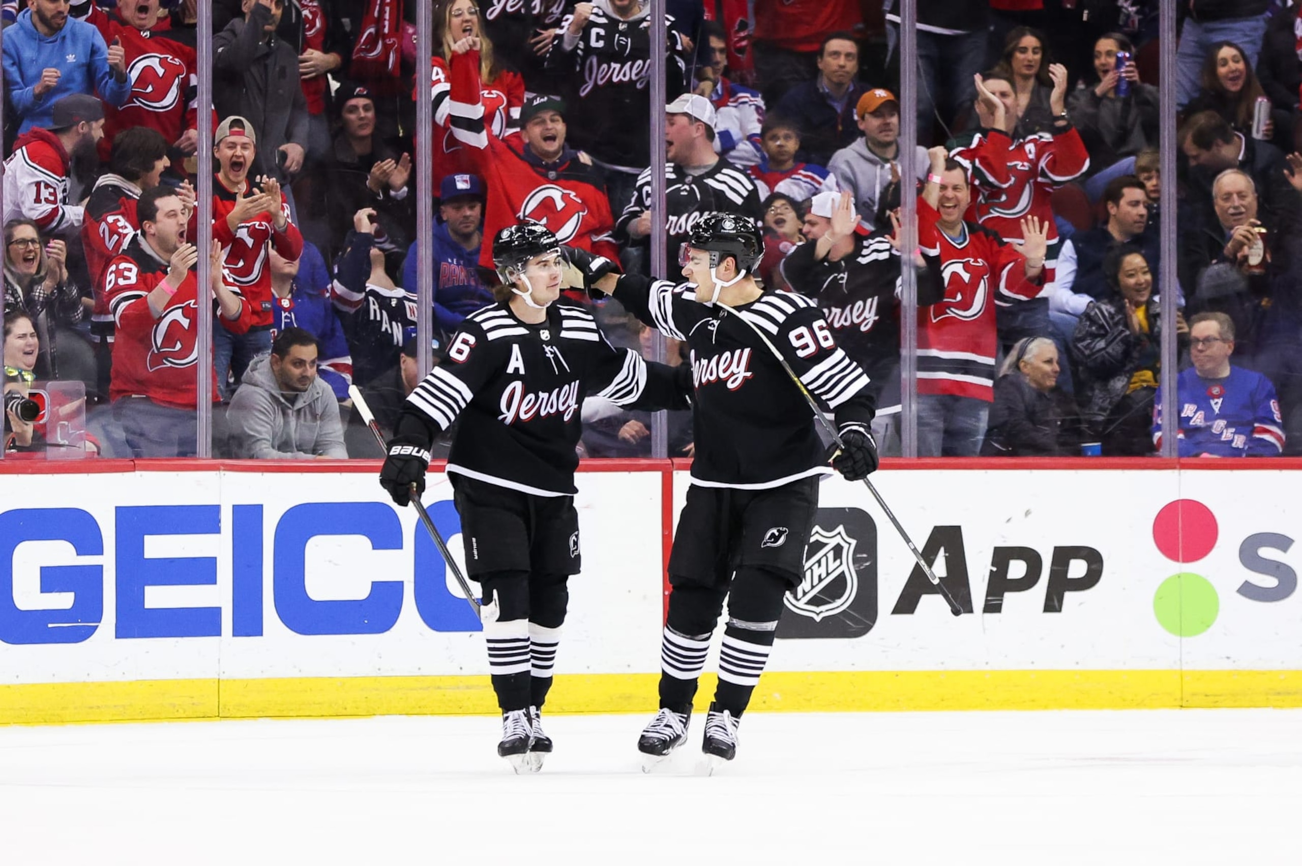 NEWARK, NJ - MARCH 30: New Jersey Devils right wing Timo Meier (96) celebrates with New Jersey Devils center Jack Hughes (86) after scoring a goal during the National Hockey League game between the New York Rangers and the New Jersey Devils on March 30, 2023 at Prudential Center in Newark, NJ. (Photo by Andrew Mordzynski/Icon Sportswire via Getty Images)