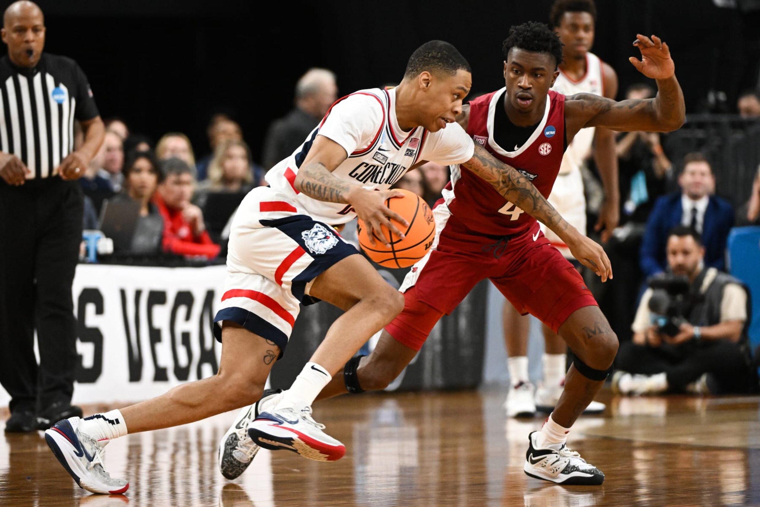 LAS VEGAS, NV - MARCH 23: Jordan Hawkins #24 of the Connecticut Huskies moves the ball past Davonte Davis #4 of the Arkansas Razorbacks during the Sweet Sixteen round of the 2023 NCAA Men's Basketball Tournament held at T-Mobile Arena on March 23, 2023 in Las Vegas, Nevada. (Photo by Brett Wilhelm/NCAA Photos via Getty Images)