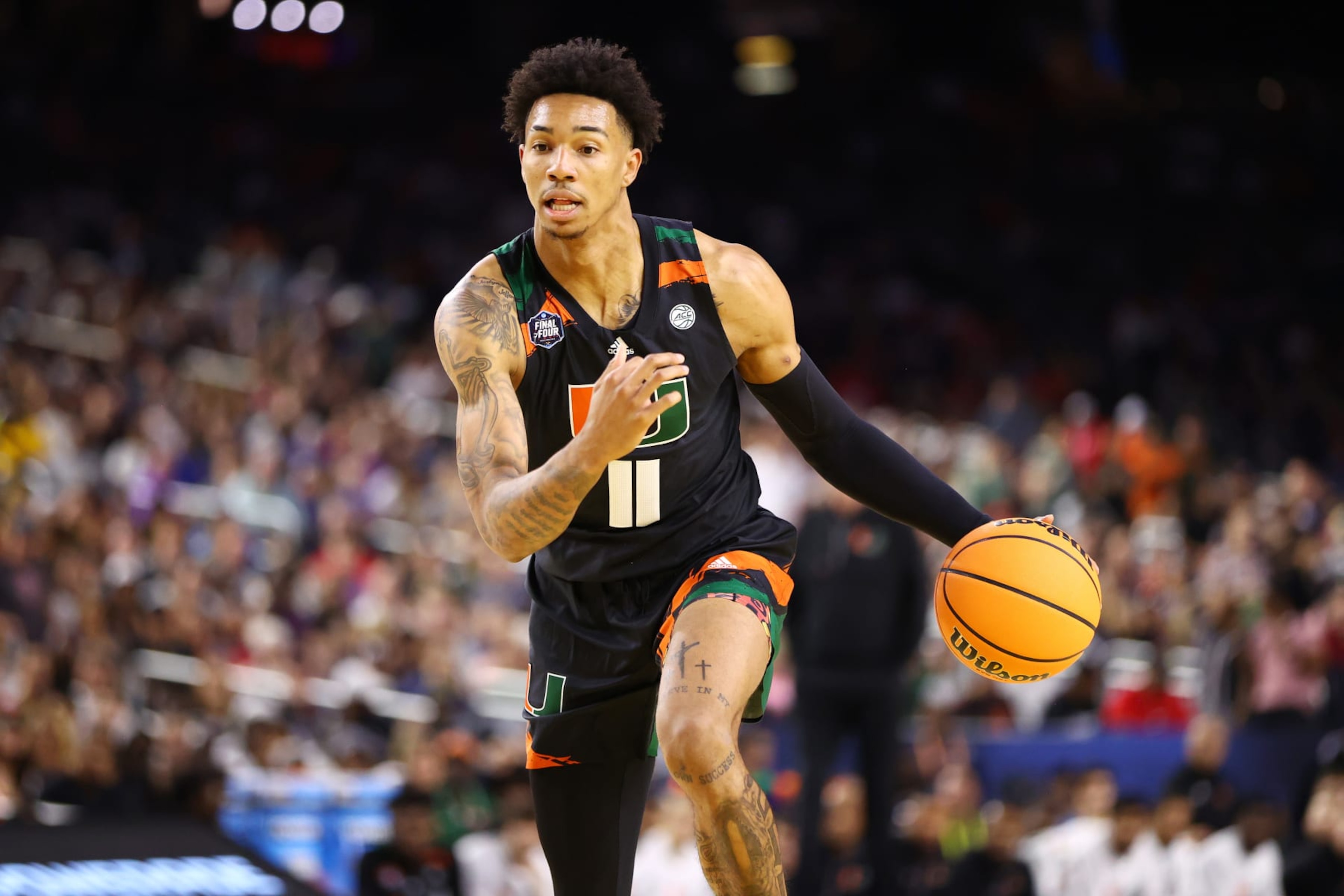 HOUSTON, TEXAS - APRIL 01: Jordan Miller #11 of the Miami Hurricanes dribbles the ball against the Connecticut Huskies during the NCAA Men’s Basketball Tournament Final Four semifinal game at NRG Stadium on April 01, 2023 in Houston, Texas. (Photo by Jamie Schwaberow/NCAA Photos via Getty Images)
