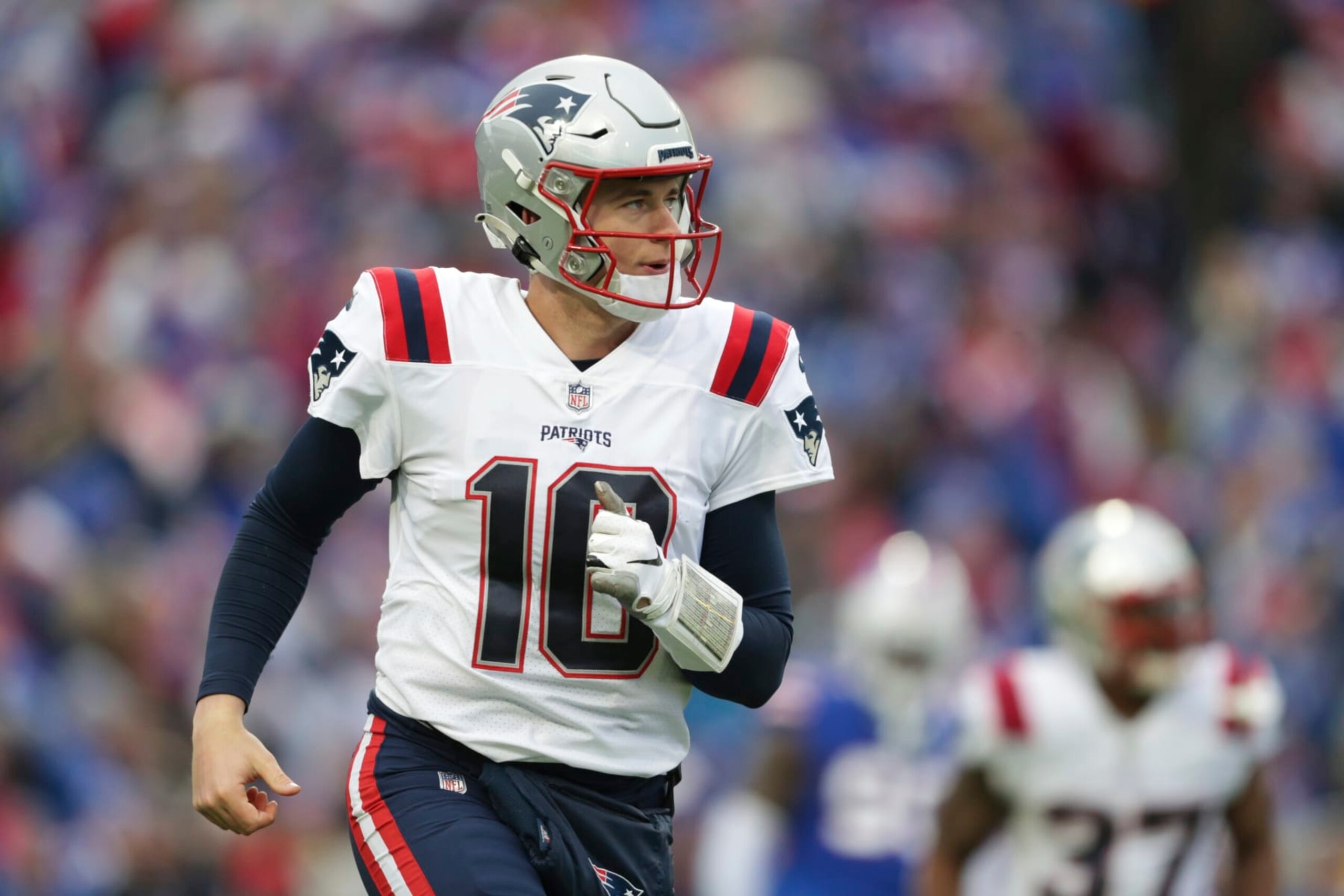 New England Patriots quarterback Mac Jones (10) runs off the field during the first half of an NFL football game against the Buffalo Bills on Sunday, Jan. 8, 2023, in Orchard Park, N.Y. (AP Photo/Joshua Bessex)