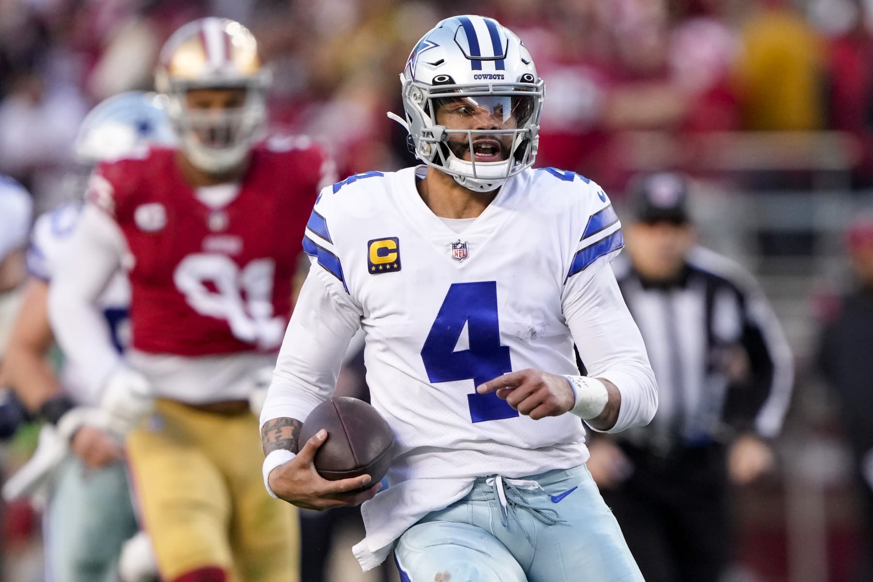 SANTA CLARA, CALIFORNIA - JANUARY 22: Dak Prescott #4 of the Dallas Cowboys carries the ball against the San Francisco 49ers during the second quarter in the NFC Divisional Playoff game at Levi's Stadium on January 22, 2023 in Santa Clara, California. (Photo by Thearon W. Henderson/Getty Images)