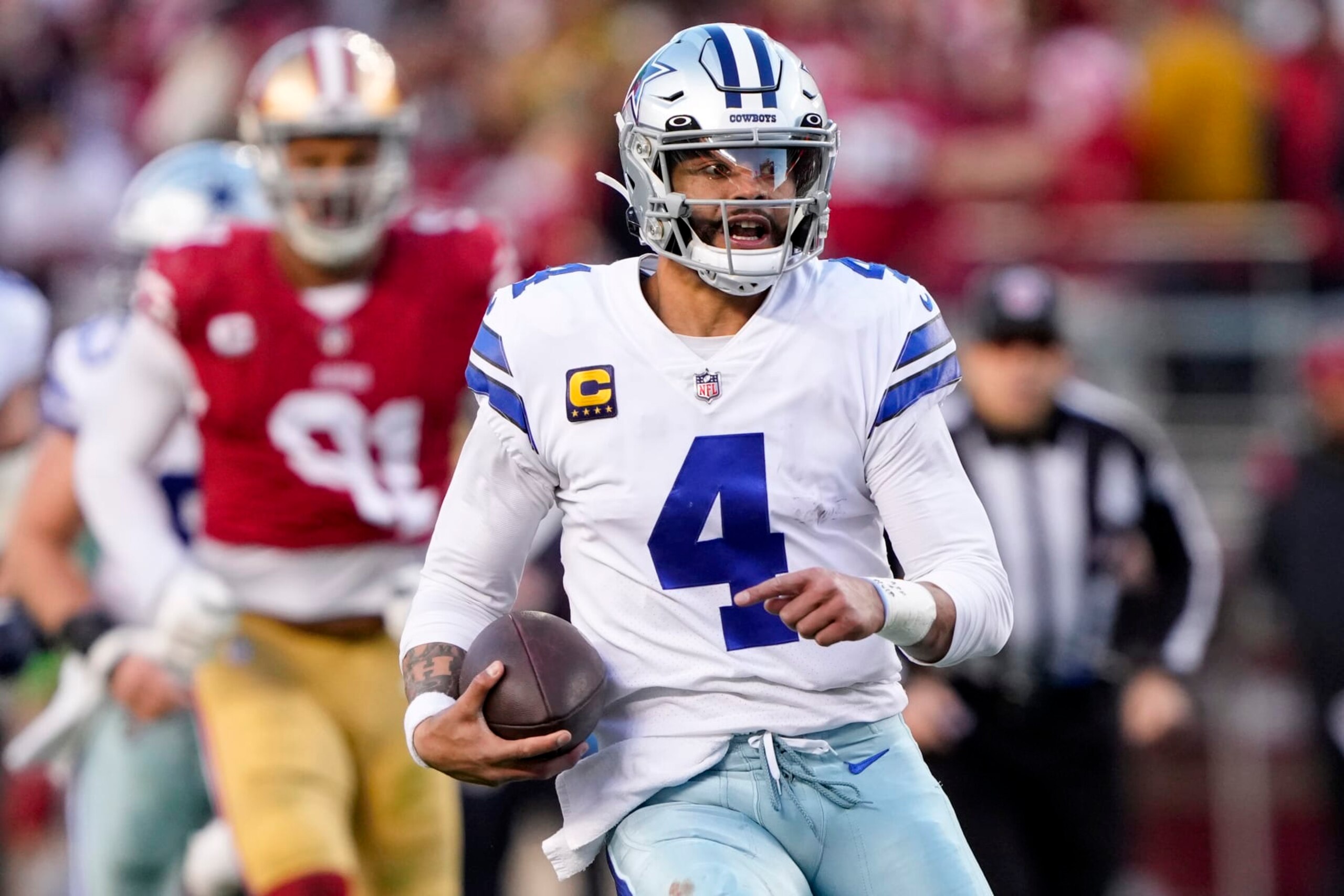 SANTA CLARA, CALIFORNIA - JANUARY 22: Dak Prescott #4 of the Dallas Cowboys carries the ball against the San Francisco 49ers during the second quarter in the NFC Divisional Playoff game at Levi's Stadium on January 22, 2023 in Santa Clara, California. (Photo by Thearon W. Henderson/Getty Images)