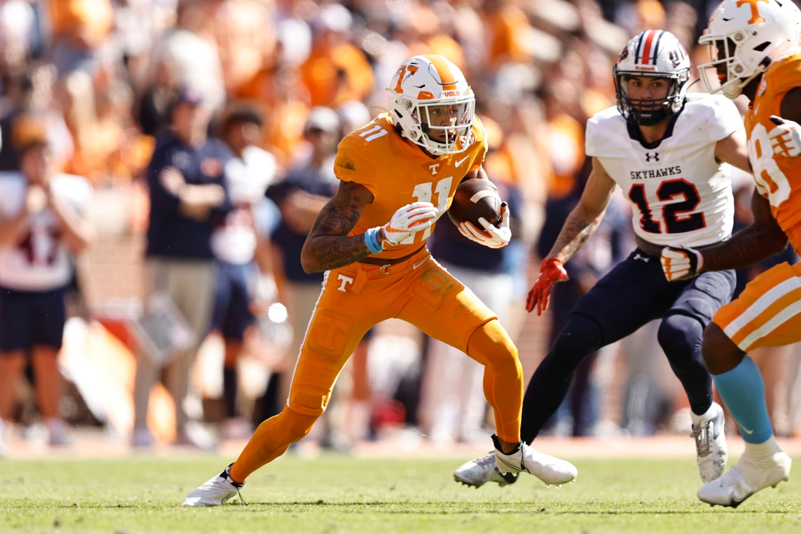 Tennessee wide receiver Jalin Hyatt (11) runs for yardage as Tennessee Martin safety Carson Evans (12) defends during the first half of an NCAA college football game Saturday, Oct. 22, 2022, in Knoxville, Tenn. (AP Photo/Wade Payne)