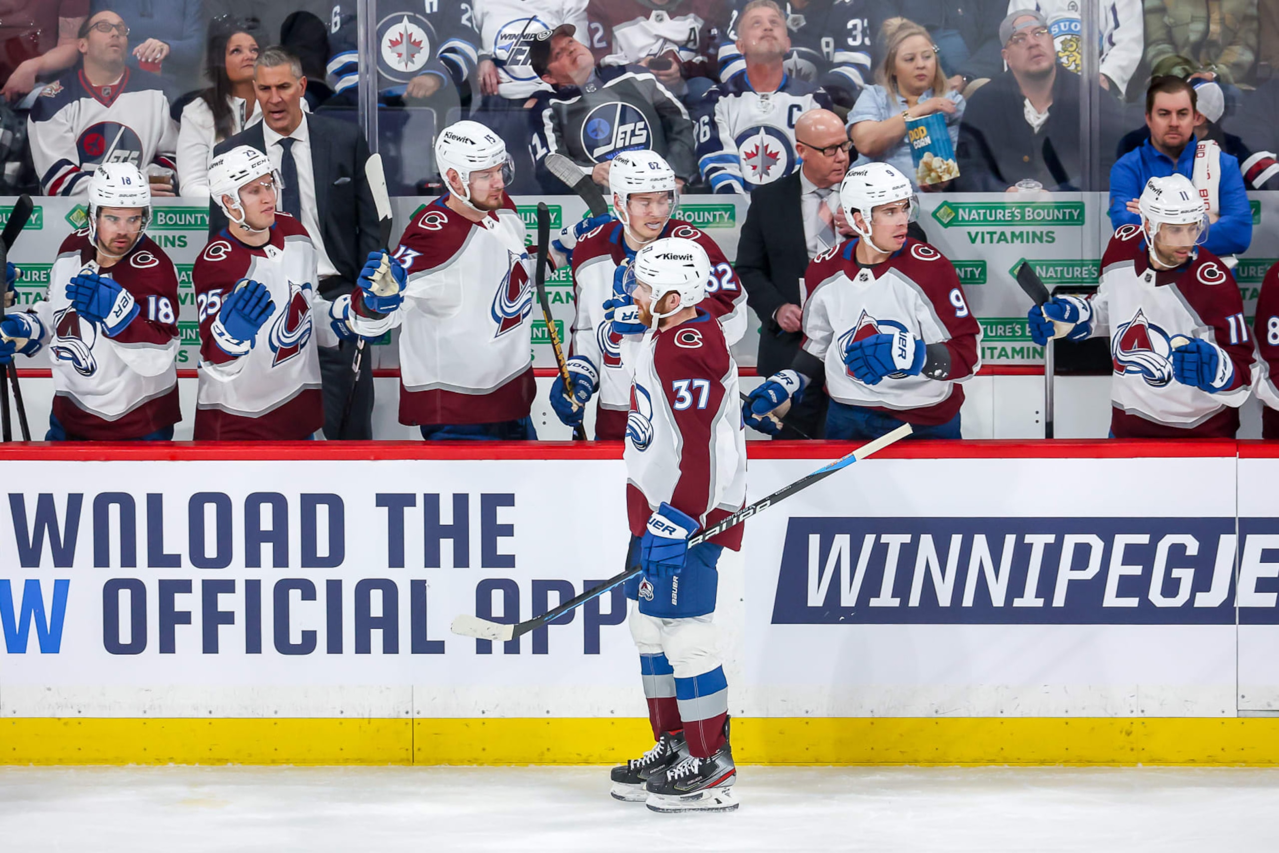 WINNIPEG, CANADA - FEBRUARY 24: J.T. Compher #37 of the Colorado Avalanche celebrates his first period goal against the Winnipeg Jets with teammates at the bench at the Canada Life Centre on February 24, 2023 in Winnipeg, Manitoba, Canada. (Photo by Jonathan Kozub/NHLI via Getty Images)