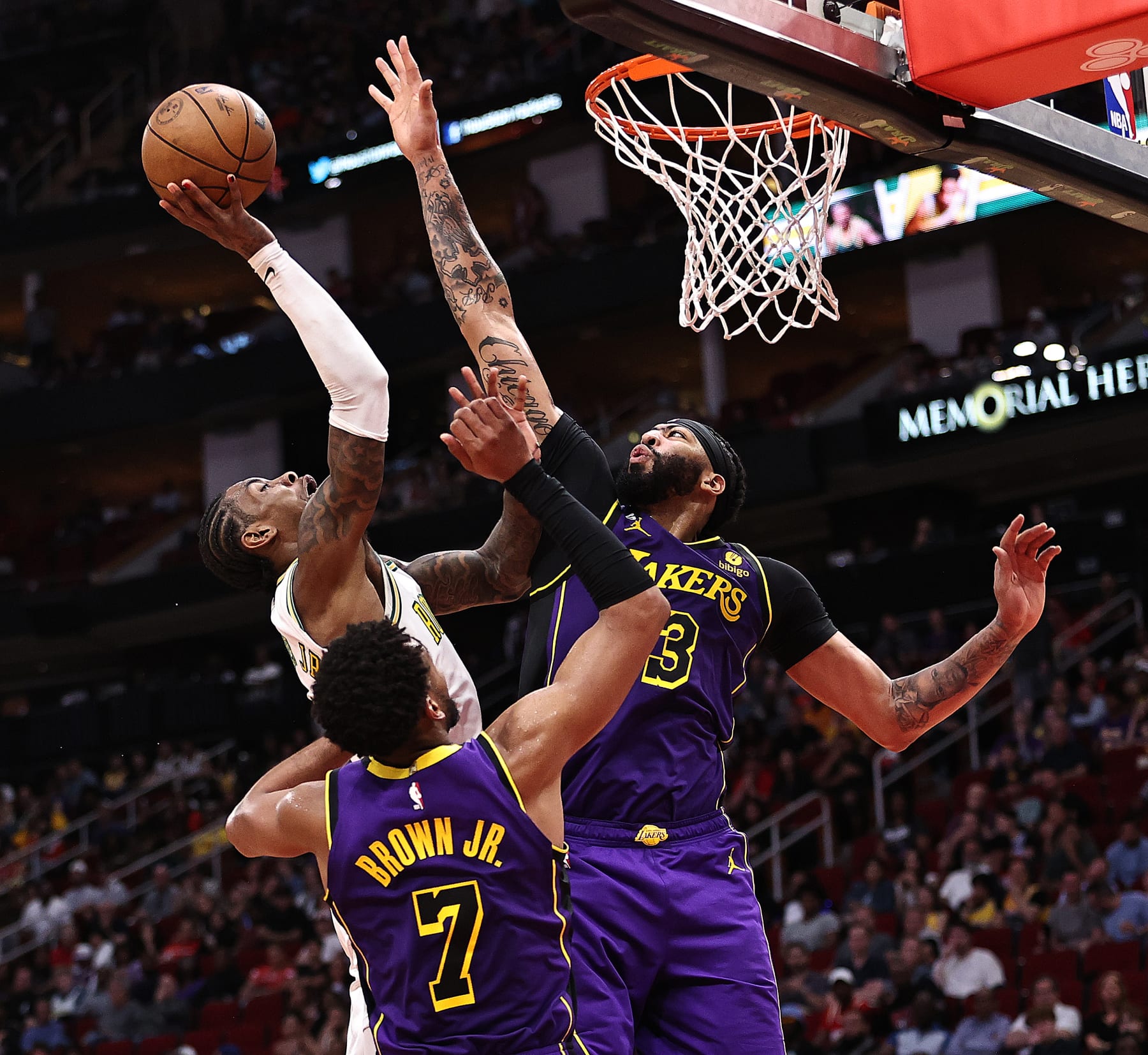 HOUSTON, TEXAS - APRIL 02: Kevin Porter Jr. #3 of the Houston Rockets goes to the basket against Anthony Davis #3 and Troy Brown Jr. #7 of the Los Angeles Lakers during the second quarter at Toyota Center on April 02, 2023 in Houston, Texas. NOTE TO USER: User expressly acknowledges and agrees that, by downloading and or using this photograph, User is consenting to the terms and conditions of the Getty Images License Agreement. (Photo by Bob Levey/Getty Images)