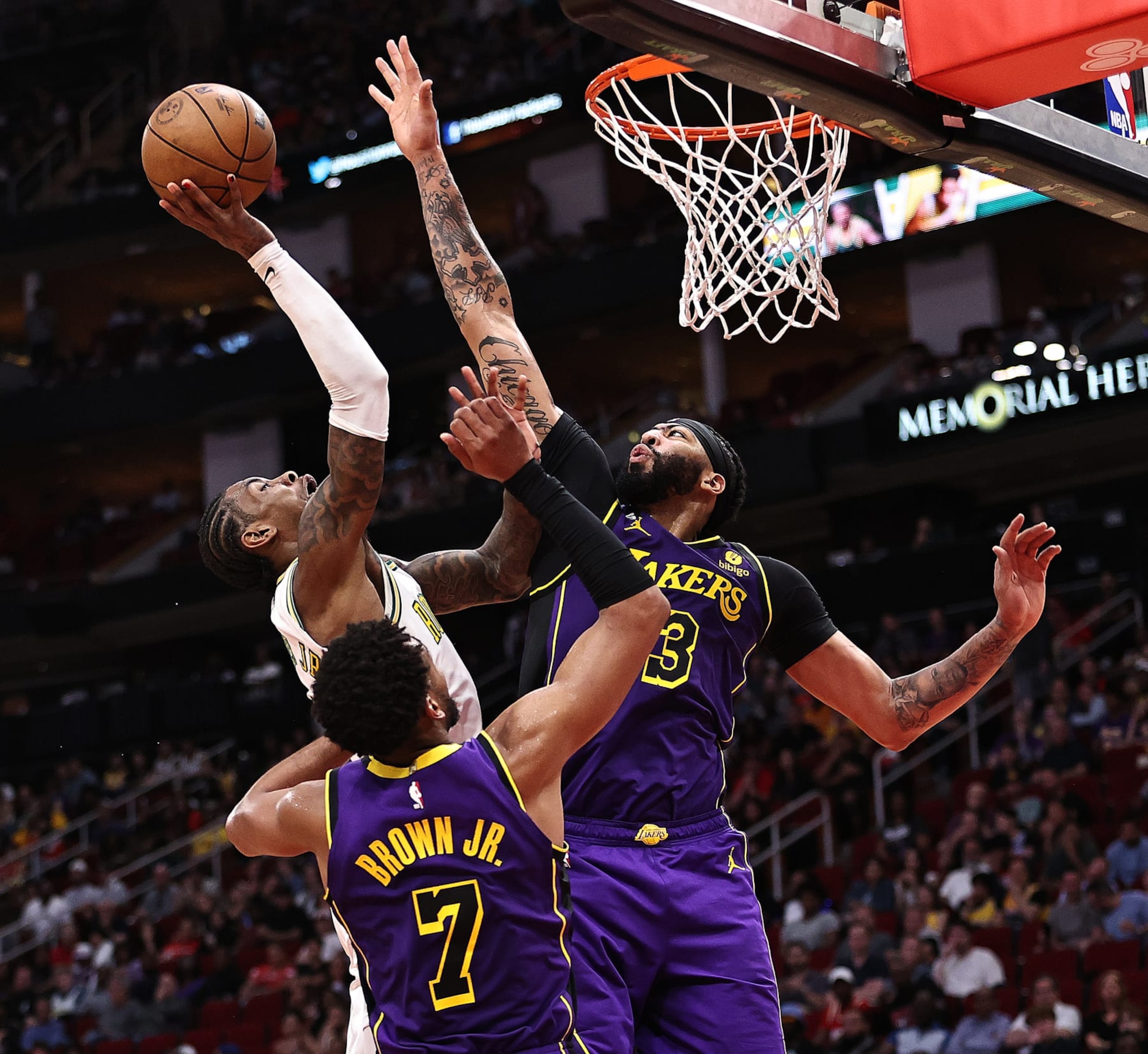 HOUSTON, TEXAS - APRIL 02: Kevin Porter Jr. #3 of the Houston Rockets goes to the basket against Anthony Davis #3 and Troy Brown Jr. #7 of the Los Angeles Lakers during the second quarter at Toyota Center on April 02, 2023 in Houston, Texas. NOTE TO USER: User expressly acknowledges and agrees that, by downloading and or using this photograph, User is consenting to the terms and conditions of the Getty Images License Agreement. (Photo by Bob Levey/Getty Images)