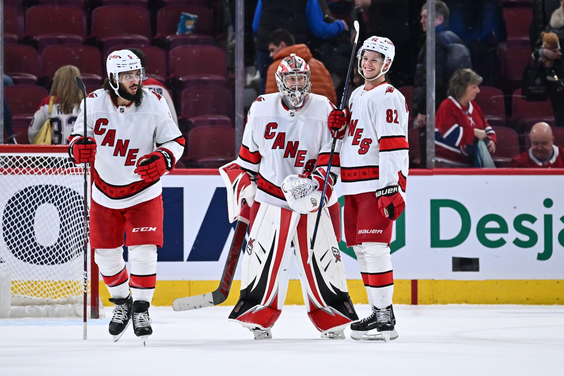 MONTREAL, CANADA - APRIL 01:  Goaltender Antti Raanta #32 and teammate Jesperi Kotkaniemi #82 of the Carolina Hurricanes celebrate their victory against the Montreal Canadiens at Centre Bell on April 1, 2023 in Montreal, Quebec, Canada.  The Carolina Hurricanes defeated the Montreal Canadiens 3-0.  (Photo by Minas Panagiotakis/Getty Images)