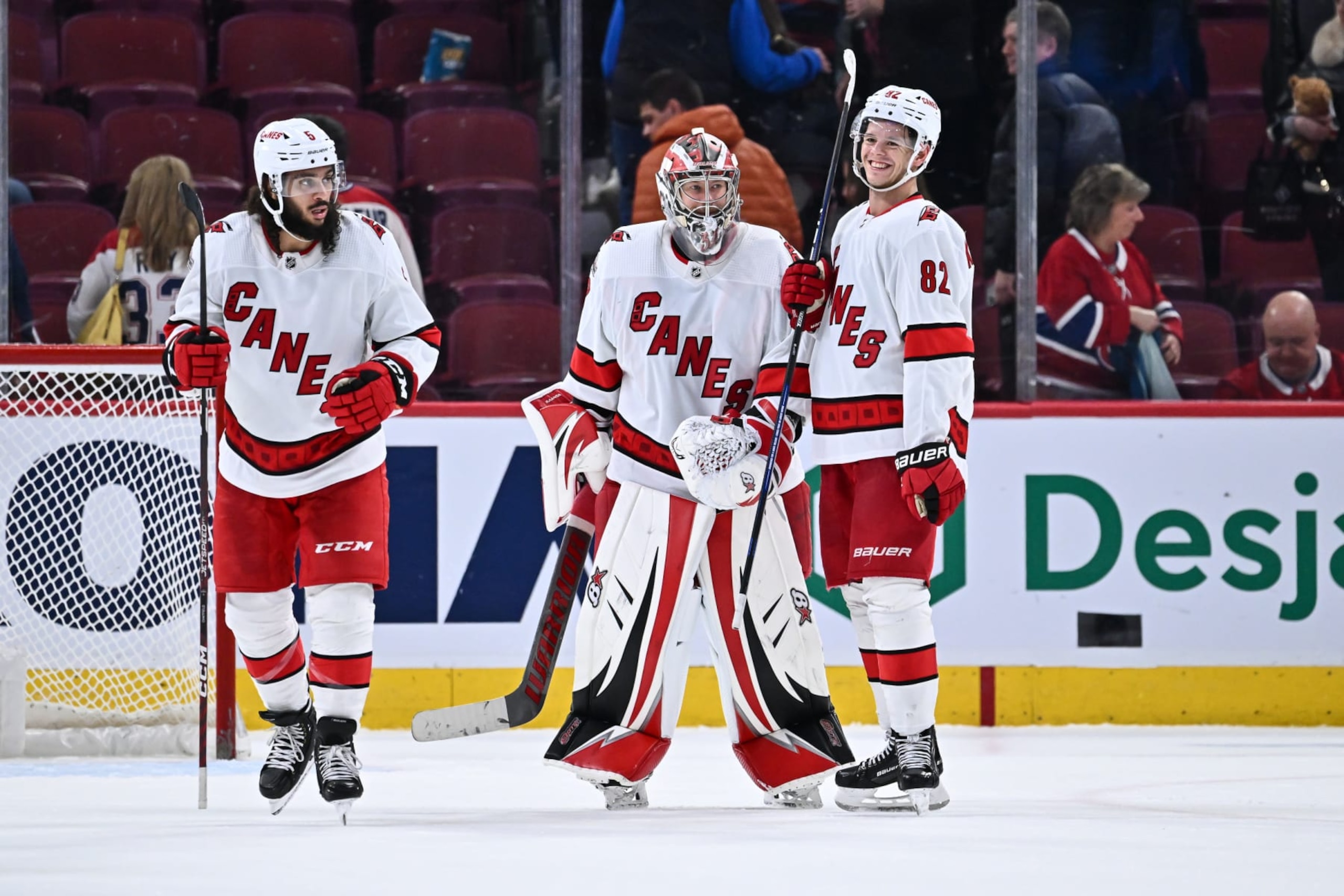MONTREAL, CANADA - APRIL 01:  Goaltender Antti Raanta #32 and teammate Jesperi Kotkaniemi #82 of the Carolina Hurricanes celebrate their victory against the Montreal Canadiens at Centre Bell on April 1, 2023 in Montreal, Quebec, Canada.  The Carolina Hurricanes defeated the Montreal Canadiens 3-0.  (Photo by Minas Panagiotakis/Getty Images)