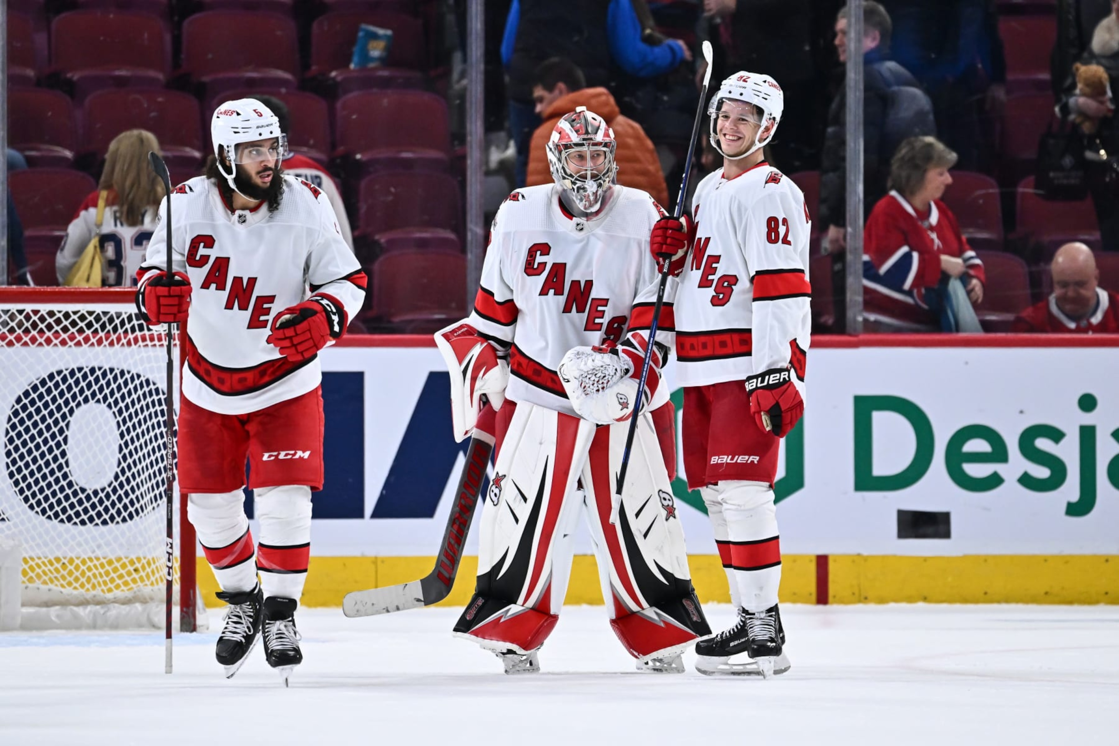 MONTREAL, CANADA - APRIL 01:  Goaltender Antti Raanta #32 and teammate Jesperi Kotkaniemi #82 of the Carolina Hurricanes celebrate their victory against the Montreal Canadiens at Centre Bell on April 1, 2023 in Montreal, Quebec, Canada.  The Carolina Hurricanes defeated the Montreal Canadiens 3-0.  (Photo by Minas Panagiotakis/Getty Images)