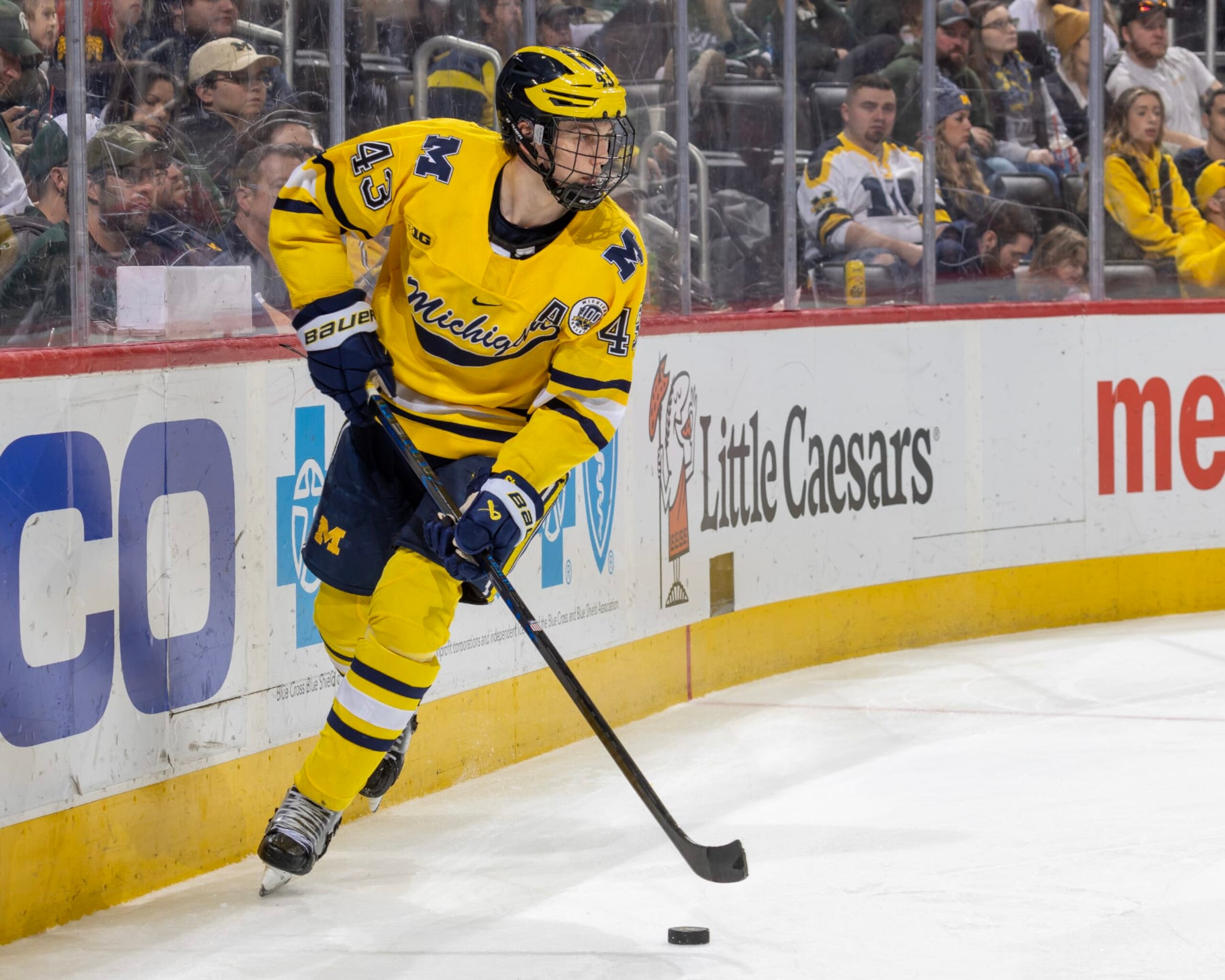 DETROIT, MI - FEBRUARY 11: Luke Hughes #43 of the Michigan Wolverines skates around the net with the puck against the Michigan State Spartans during the second period of an NCAA Mens college hockey Dual in the D game at Little Caesars Arena on February 11, 2023 in Detroit, Michigan. The Wolverines defeated the Spartans 4-3 in O.T. (Photo by Dave Reginek/Getty Images)