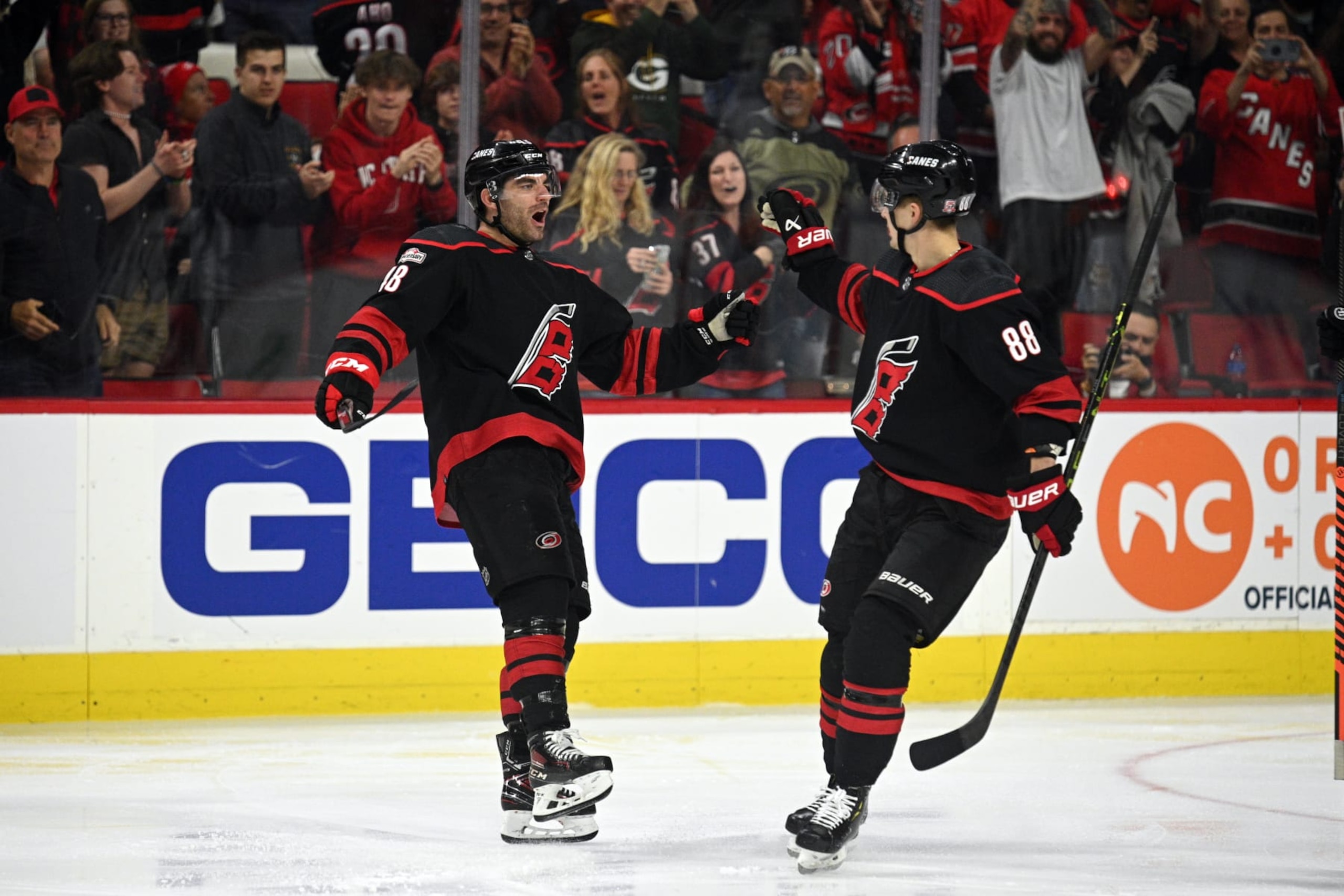 RALEIGH, NC - APRIL 02: Carolina Hurricanes Left Wing Jordan Martinook (48) and Carolina Hurricanes Right Wing Martin Necas (88) celebrate scoring a goal during the game between the New York Islanders and the Carolina Hurricanes on April 2, 2023 at PNC Arena in Raleigh, North Carolina. (Photo by Katherine Gawlik/Icon Sportswire via Getty Images)