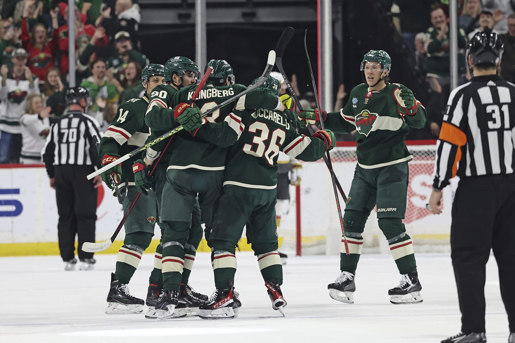 Minnesota Wild defenseman John Klingberg (3) celebrates with teammates after scoring against the Vegas Golden Knights during the second period of an NHL hockey game Monday, April 3, 2023, in St. Paul, Minn. (AP Photo/Stacy Bengs)