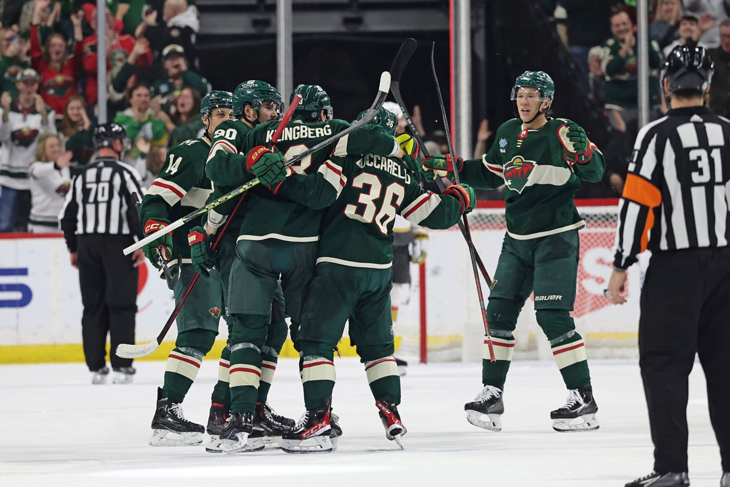 Minnesota Wild defenseman John Klingberg (3) celebrates with teammates after scoring against the Vegas Golden Knights during the second period of an NHL hockey game Monday, April 3, 2023, in St. Paul, Minn. (AP Photo/Stacy Bengs)