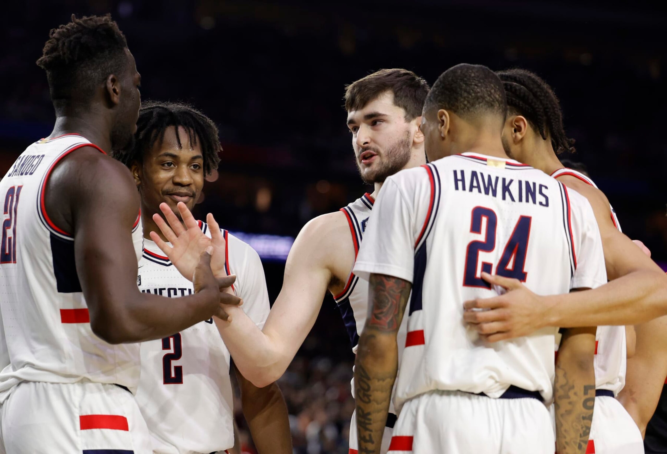 HOUSTON, TEXAS - APRIL 03: Alex Karaban #11 of the Connecticut Huskies celebrates with Adama Sanogo #21 during the second half against the San Diego State Aztecs during the NCAA Men's Basketball Tournament National Championship game at NRG Stadium on April 03, 2023 in Houston, Texas. (Photo by Carmen Mandato/Getty Images) HOUSTON, TEXAS - APRIL 03: Alex Karaban #11 of the Connecticut Huskies celebrates with Adama Sanogo #21 during the second half against the San Diego State Aztecs during the NCAA Men's Basketball Tournament National Championship game at NRG Stadium on April 03, 2023 in Houston, Texas. (Photo by Carmen Mandato/Getty Images)