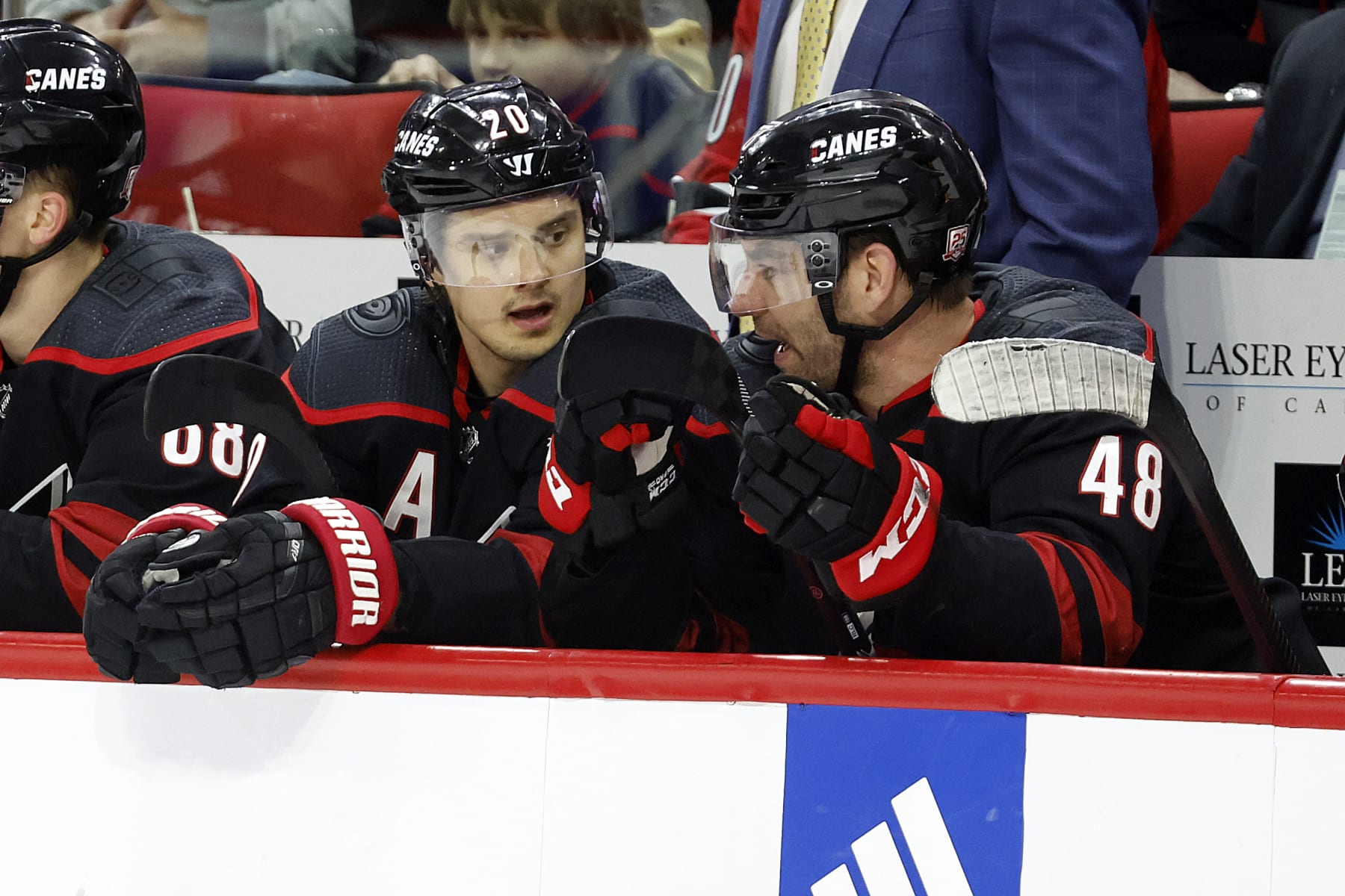 Carolina Hurricanes' Sebastian Aho (20) talks with teammate Jordan Martinook (48) during the second period of an NHL hockey game against the New York Islanders in Raleigh, N.C., Sunday, April 2, 2023. (AP Photo/Karl B DeBlaker)