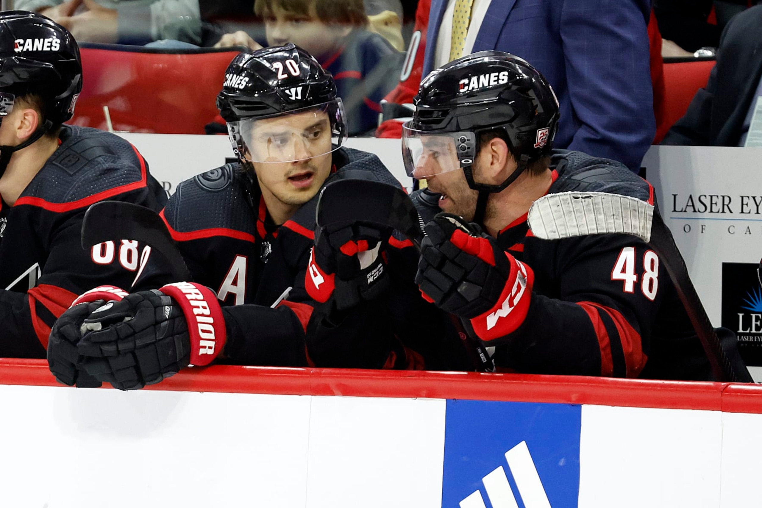 Carolina Hurricanes' Sebastian Aho (20) talks with teammate Jordan Martinook (48) during the second period of an NHL hockey game against the New York Islanders in Raleigh, N.C., Sunday, April 2, 2023. (AP Photo/Karl B DeBlaker)