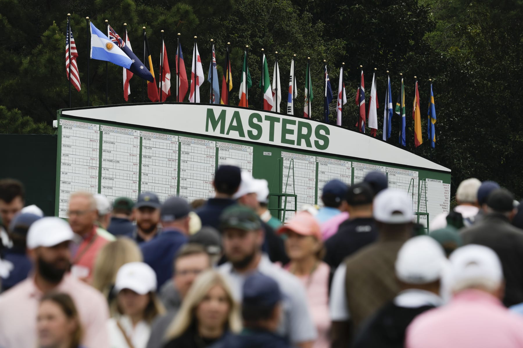 Patrons move on the course during a practice for the Masters golf tournament at Augusta National Golf Club, Monday, April 3, 2023, in Augusta, Ga. (AP Photo/Charlie Riedel)