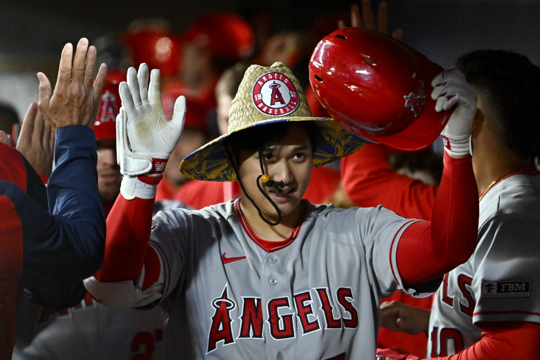 SEATTLE, WASHINGTON - APRIL 03: Shohei Ohtani #17 of the Los Angeles Angels celebrates with teammates after hitting a two run home run during the fifth inning against the Seattle Mariners at T-Mobile Park on April 03, 2023 in Seattle, Washington. (Photo by Alika Jenner/Getty Images)