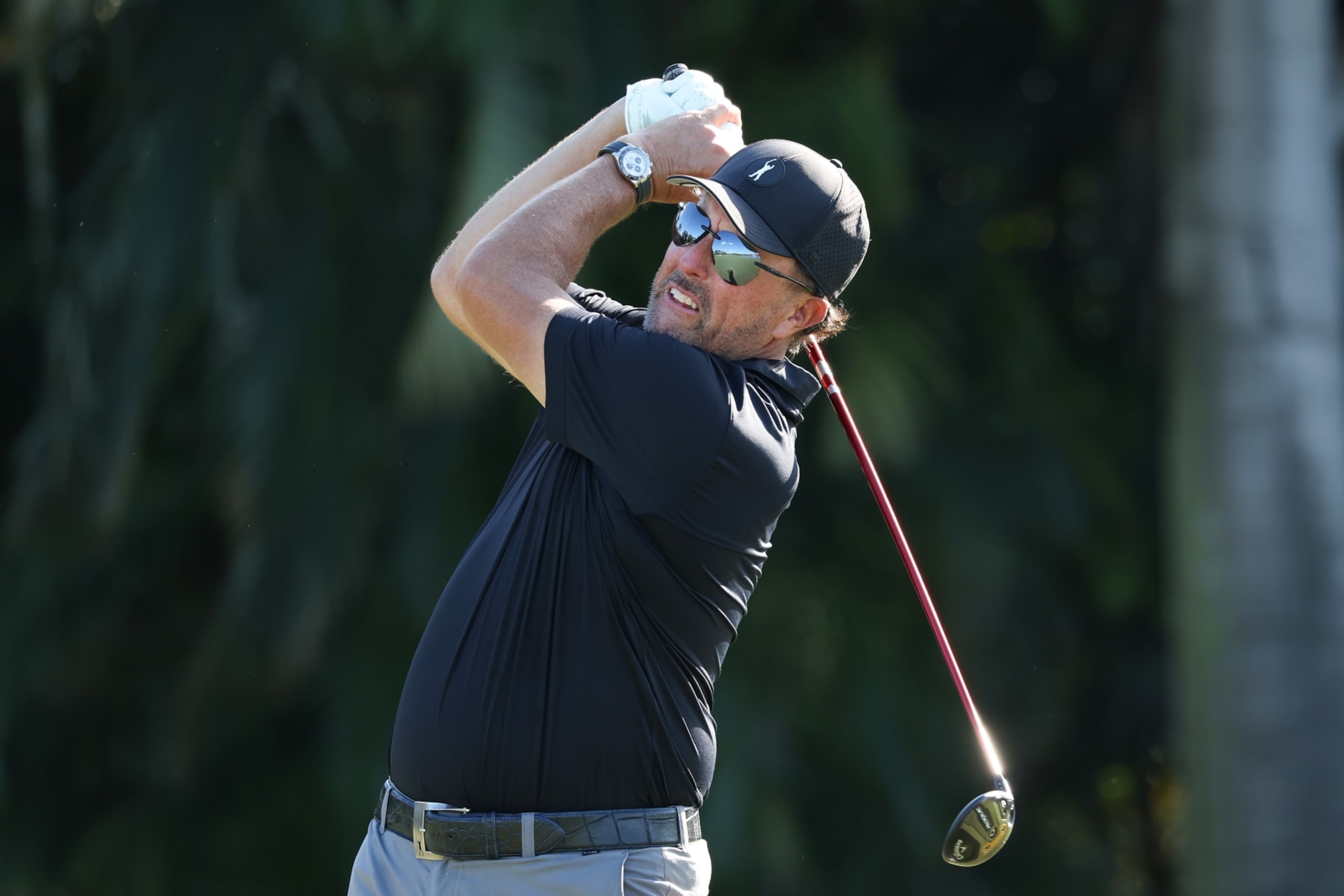 DORAL, FLORIDA - OCTOBER 27: Team Captain Phil Mickelson of Hy Flyers GC plays an approach shot on the tenth hole during a pro-am prior to the LIV Golf Invitational - Miami at Trump National Doral Miami on October 27, 2022 in Doral, Florida. (Photo by Jonathan Ferrey/LIV Golf via Getty Images)