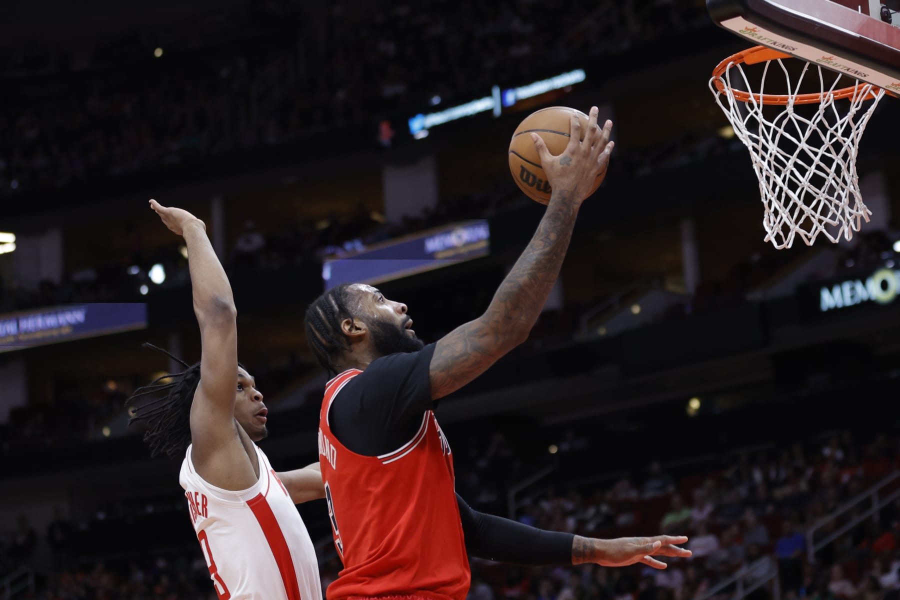 HOUSTON, TEXAS - MARCH 11: Andre Drummond #3 of the Chicago Bulls drives to the net ahead of Josh Christopher #9 of the Houston Rockets during the first half at Toyota Center on March 11, 2023 in Houston, Texas. NOTE TO USER: User expressly acknowledges and agrees that, by downloading and or using this photograph, User is consenting to the terms and conditions of the Getty Images License Agreement. (Photo by Carmen Mandato/Getty Images)