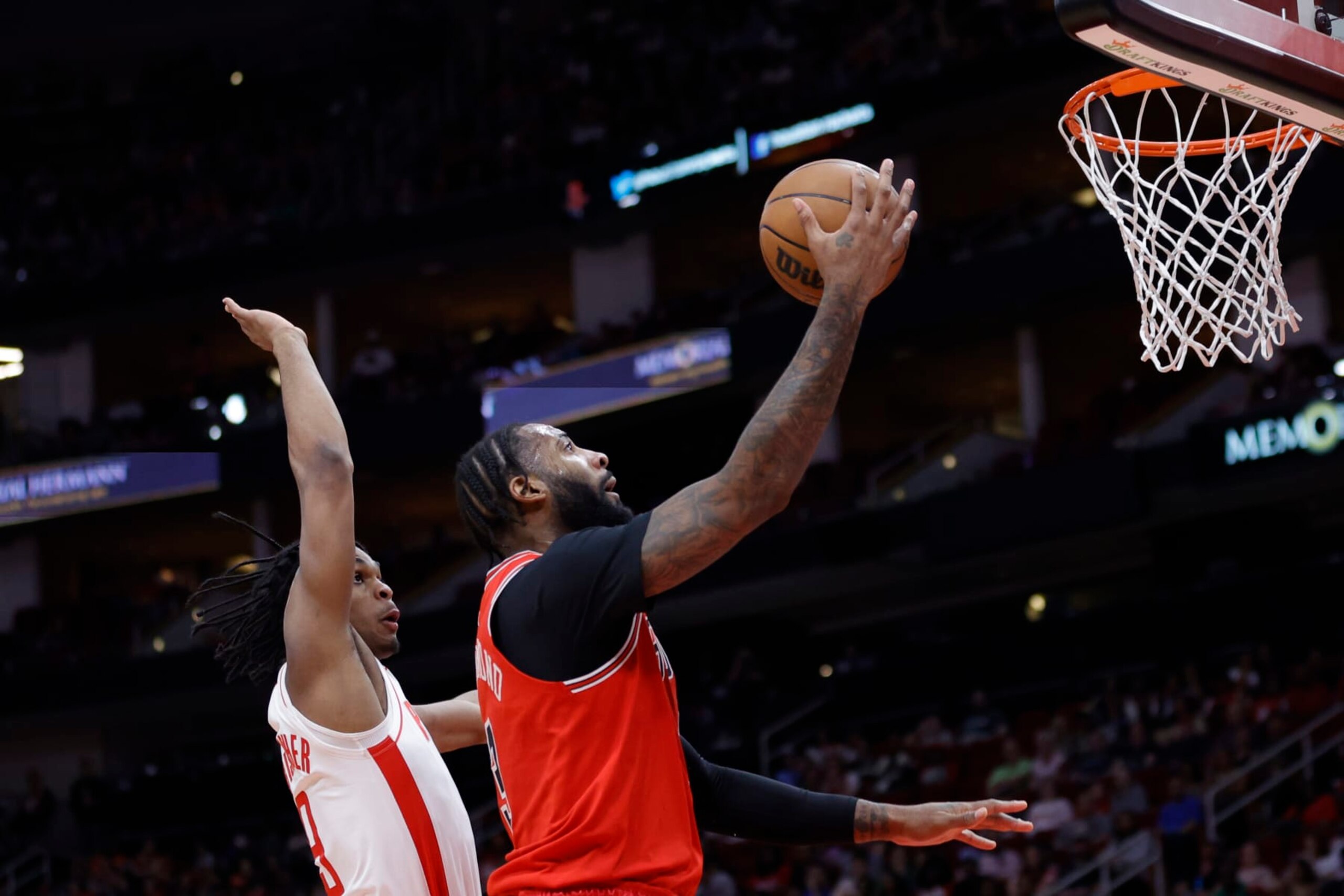 HOUSTON, TEXAS - MARCH 11: Andre Drummond #3 of the Chicago Bulls drives to the net ahead of Josh Christopher #9 of the Houston Rockets during the first half at Toyota Center on March 11, 2023 in Houston, Texas. NOTE TO USER: User expressly acknowledges and agrees that, by downloading and or using this photograph, User is consenting to the terms and conditions of the Getty Images License Agreement. (Photo by Carmen Mandato/Getty Images)